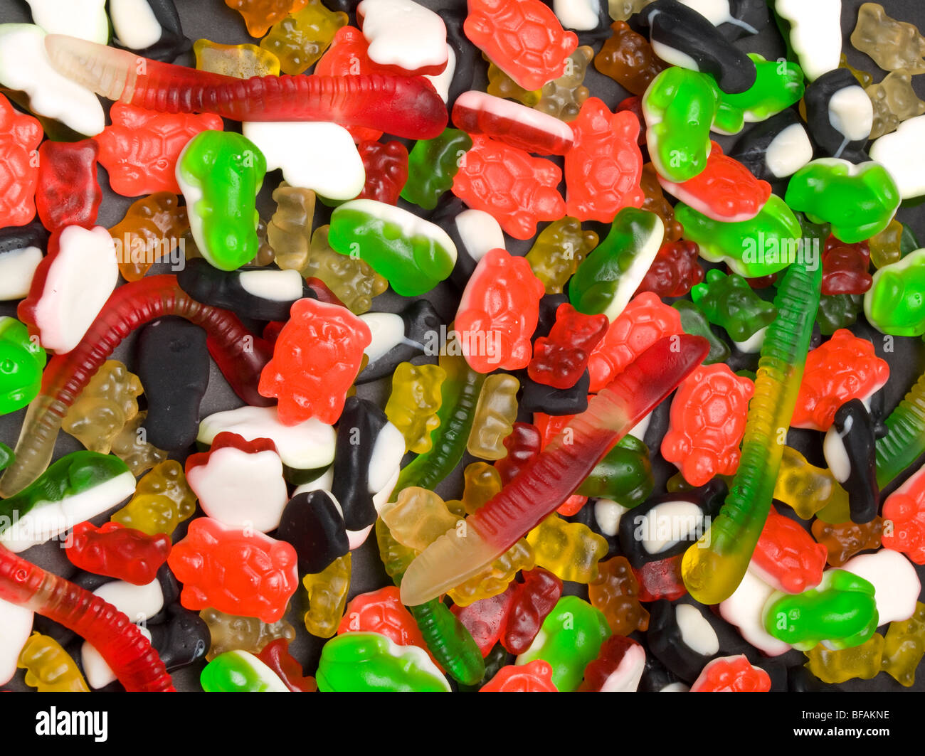 Eine Auswahl an Gummibärchen Bonbons auf einer schwarzen Platte. Stockfoto