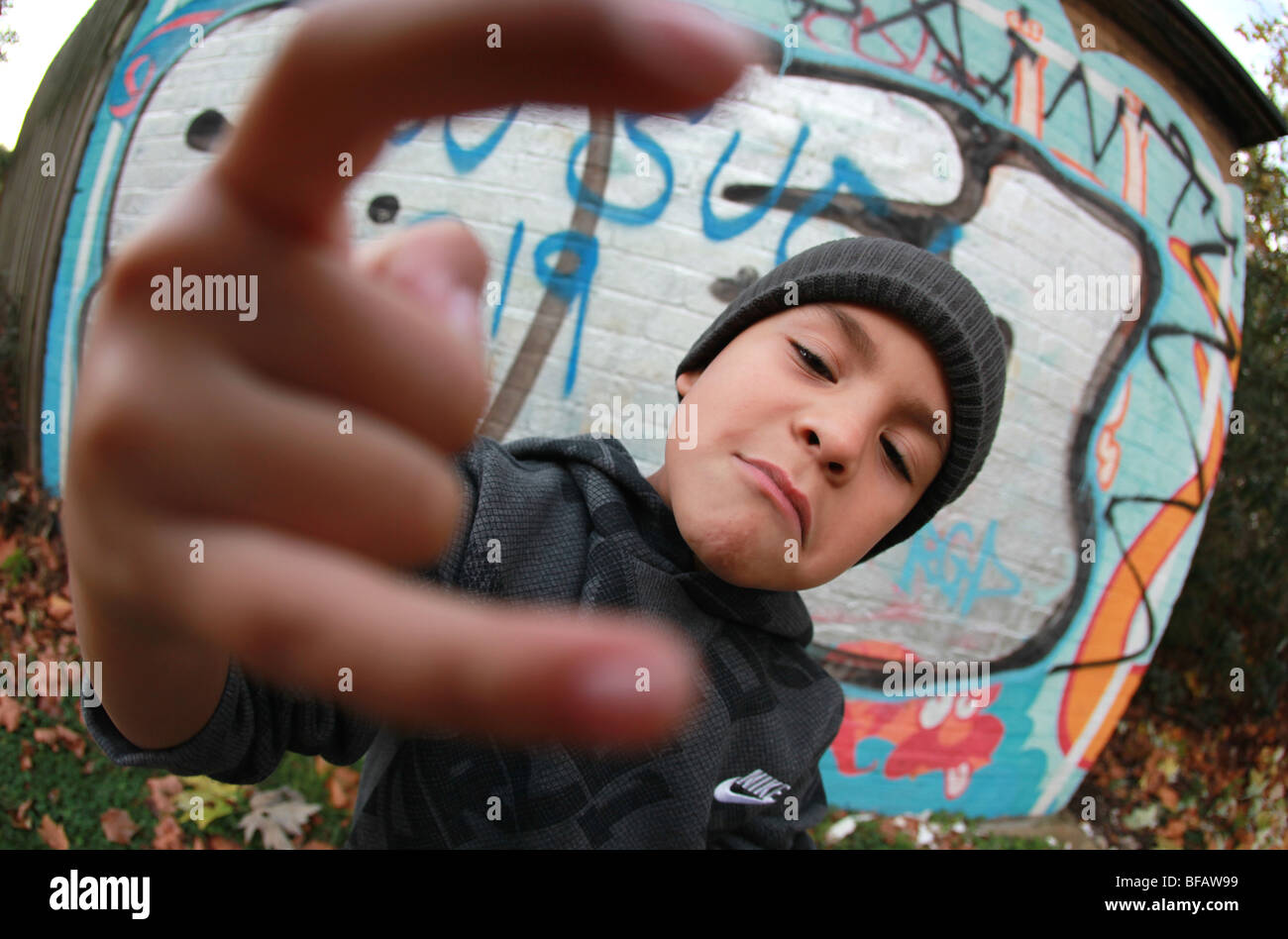 Kleiner Junge gab Haltung von Graffitiwand Stockfoto