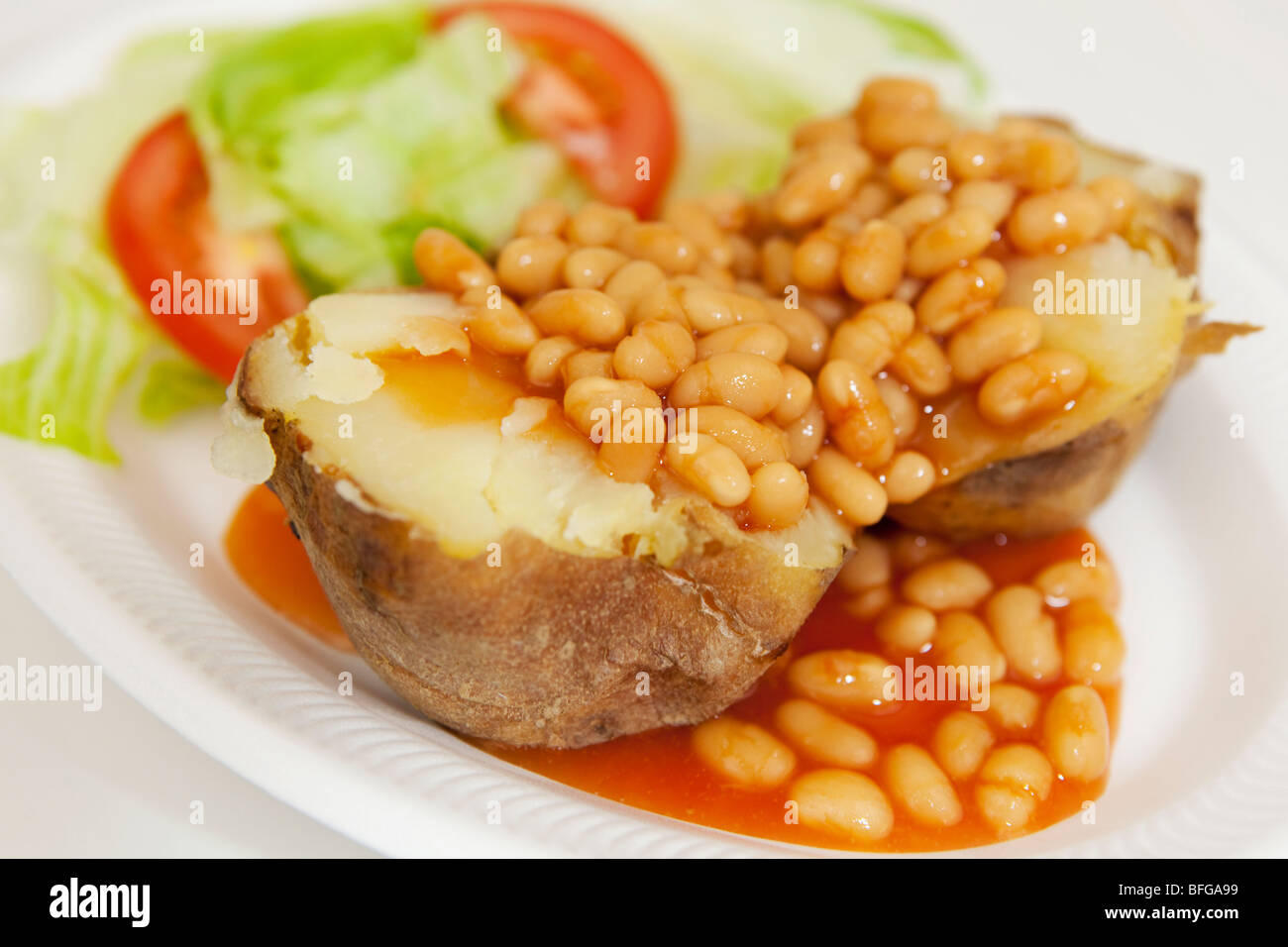Ofenkartoffeln mit gebackenen Bohnen und Salat garniert Stockfoto