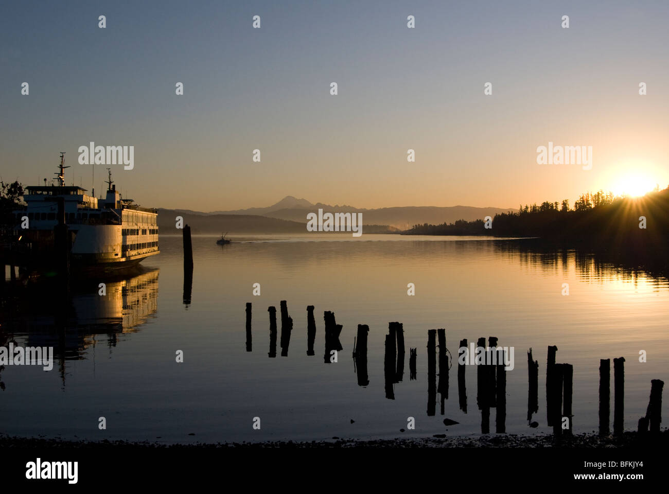 Washington State Ferry angedockt bei Sonnenaufgang in Anacortes, Washington, den Cascade Mountains im Hintergrund. Stockfoto