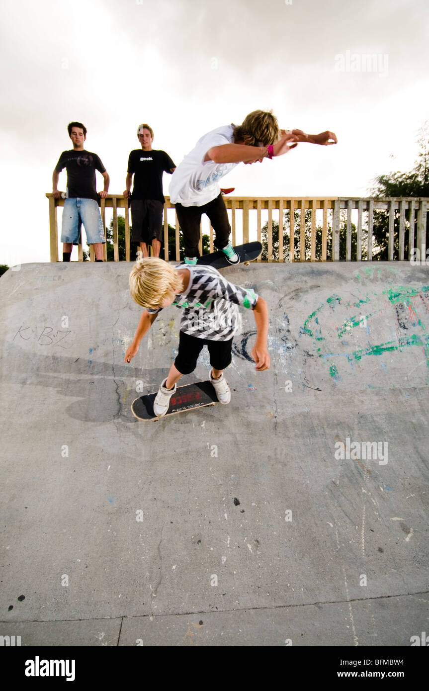 3 jungen machen Tricks im Skatepark mit Sonnenuntergang, Cambridge, Neuseeland, Stockfoto