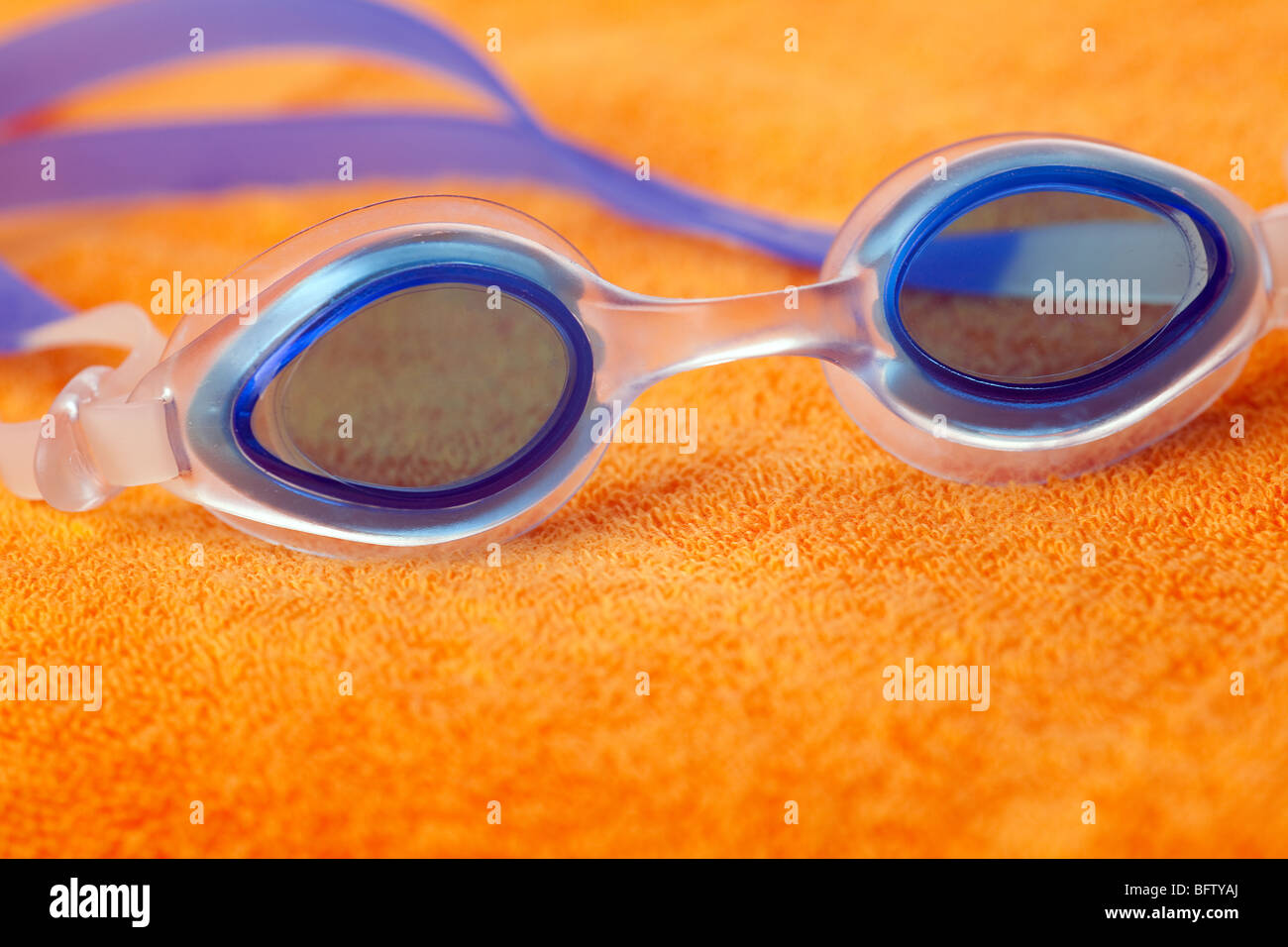 Schwimmen Brille auf orange Handtuch Stockfoto