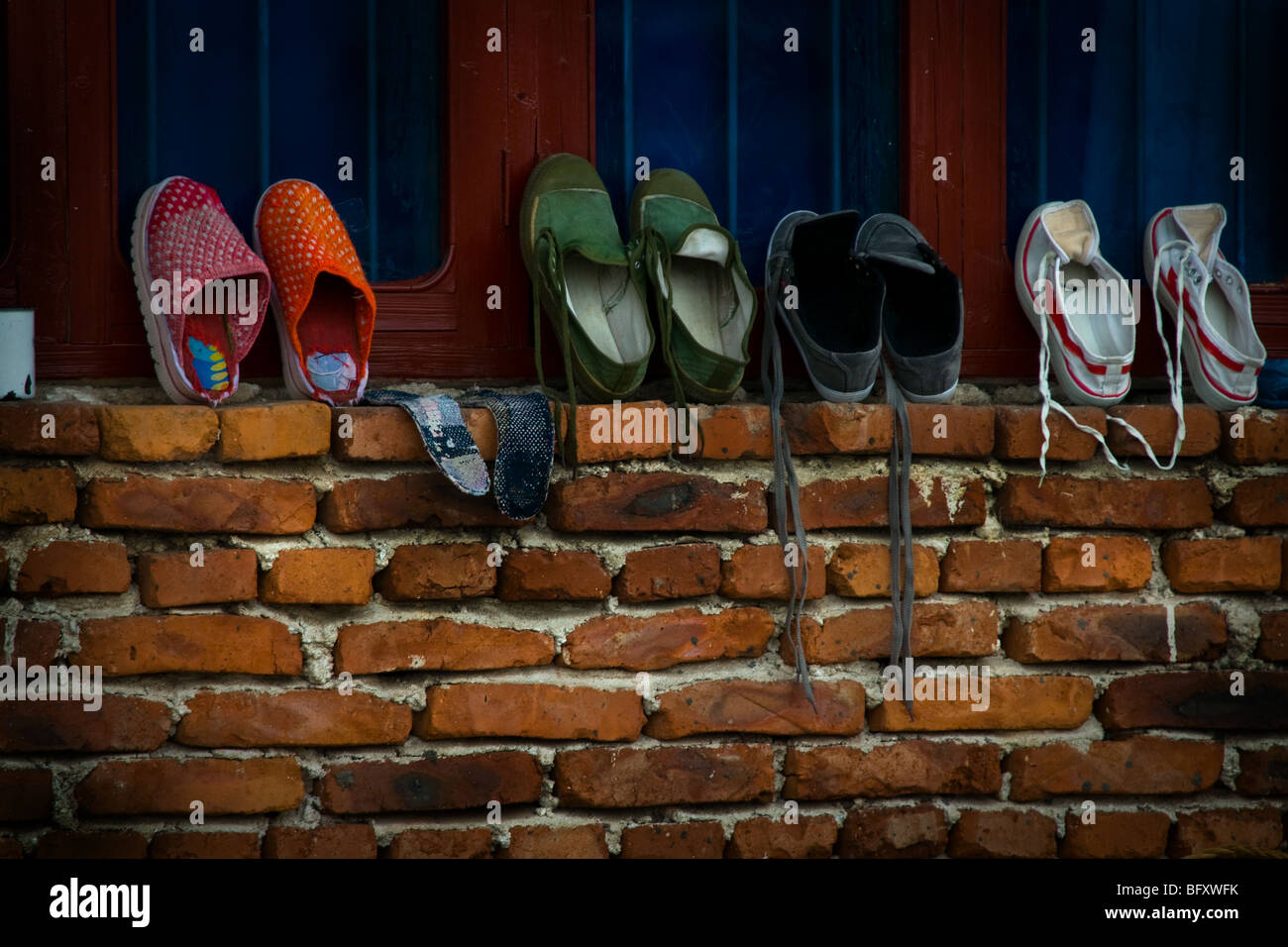 Vier Paar Schuhe an der Wand in einem Dorf in Jiangxi, China Stockfoto