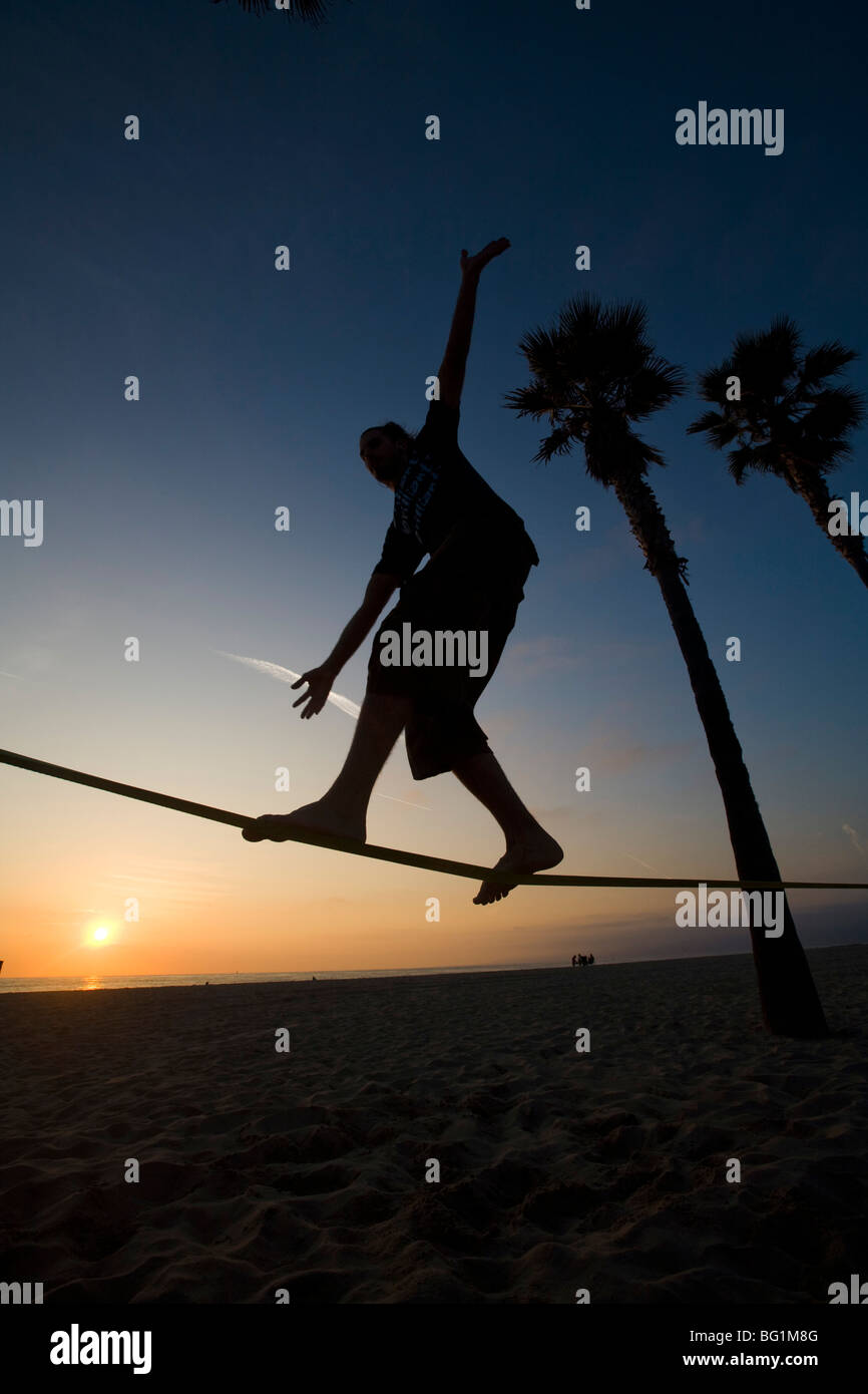 Slacklinen - Blanacing auf eine Slackline - Venice Beach, Los Angeles County, California, Vereinigte Staaten von Amerika Stockfoto