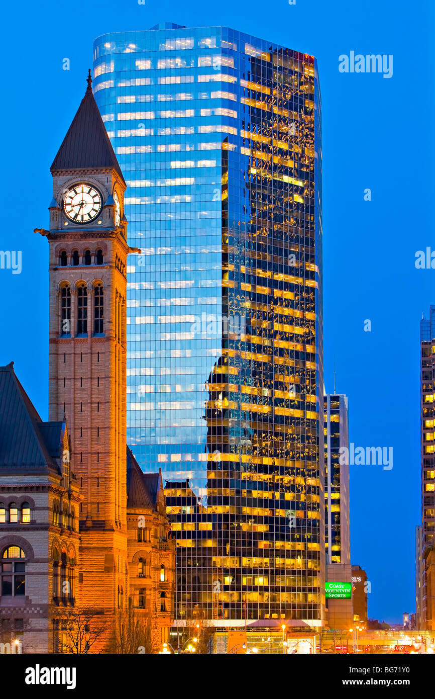 Uhrturm des alten Rathauses und einem modernen Gebäude in der Innenstadt von Toronto in der Abenddämmerung, Ontario, Kanada. Stockfoto