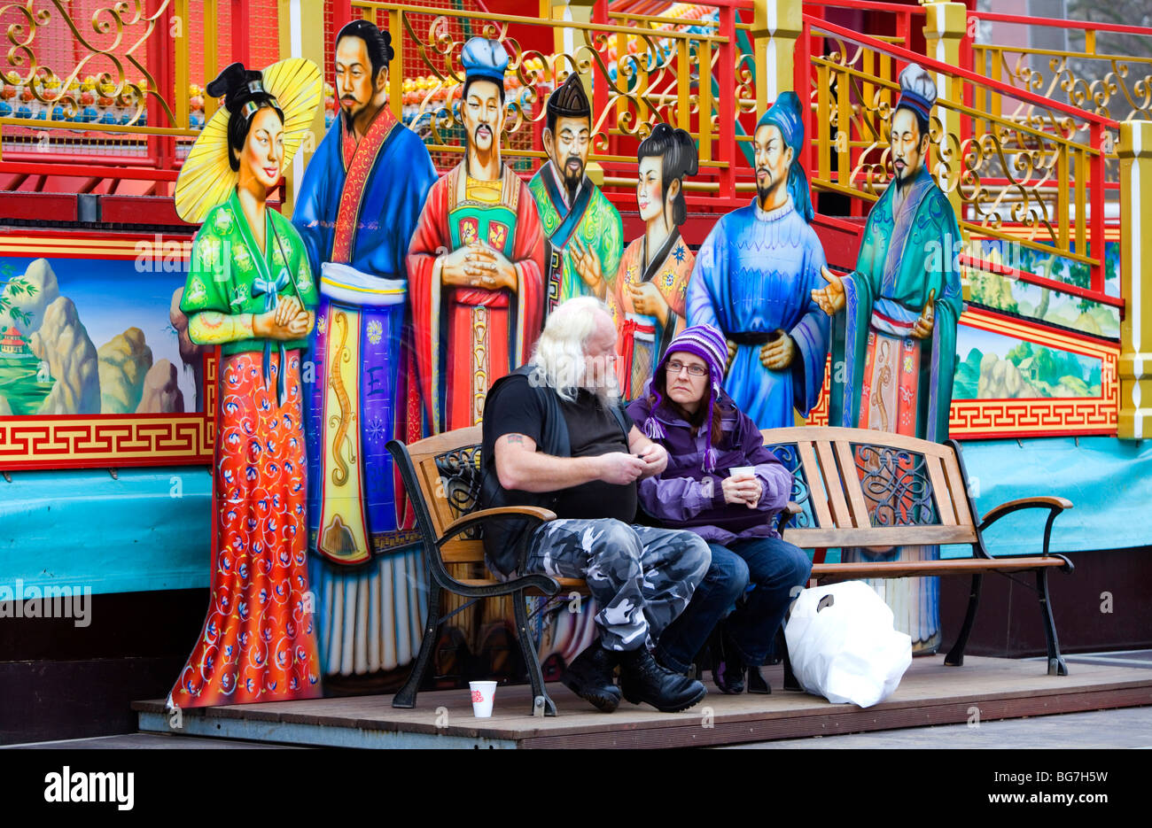 Paar der orientalischen Figuren hinter offenbar vergessen. Deutsche Weihnachten Winter Wonderland Messe, Hyde Park, London, England, Vereinigtes Königreich Stockfoto