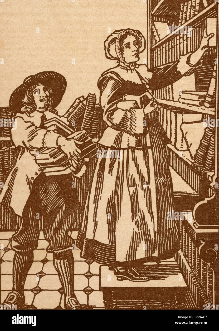 Männliche und weibliche Buchhändler arbeiten im 17. Jahrhundert Bookshop. Stockfoto