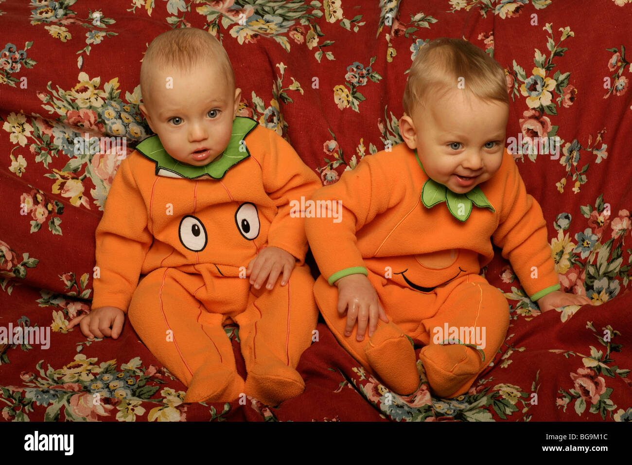 Baby Zwillinge 1 Jahr alt, jungen gekleidet wie ein Kürbis Stockfoto