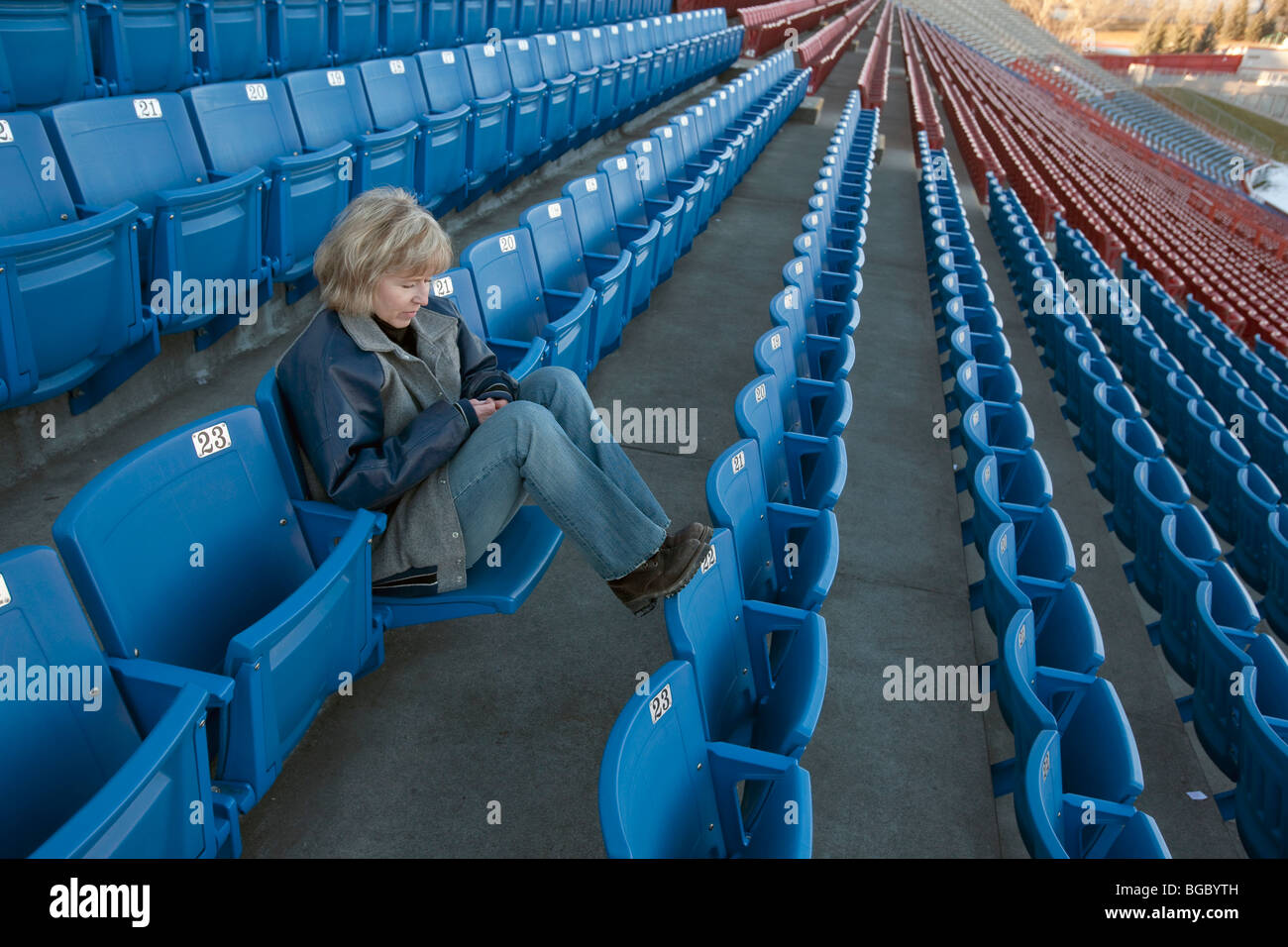 Frau sitzt allein im Stadion Stockfoto