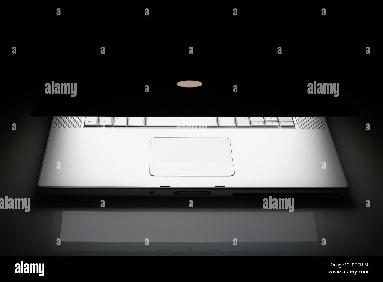 Silber Laptop auf einem schwarzen Hintergrund mit Reflexion und Kopie. Stockfoto