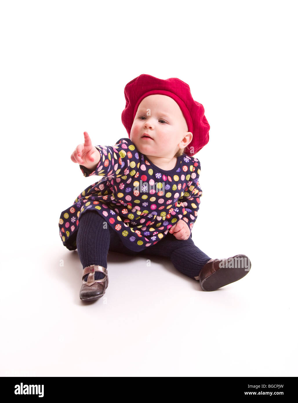 1 Jahr alt kleines Mädchen Punkte mit dem Finger isoliert auf weiss Stockfoto