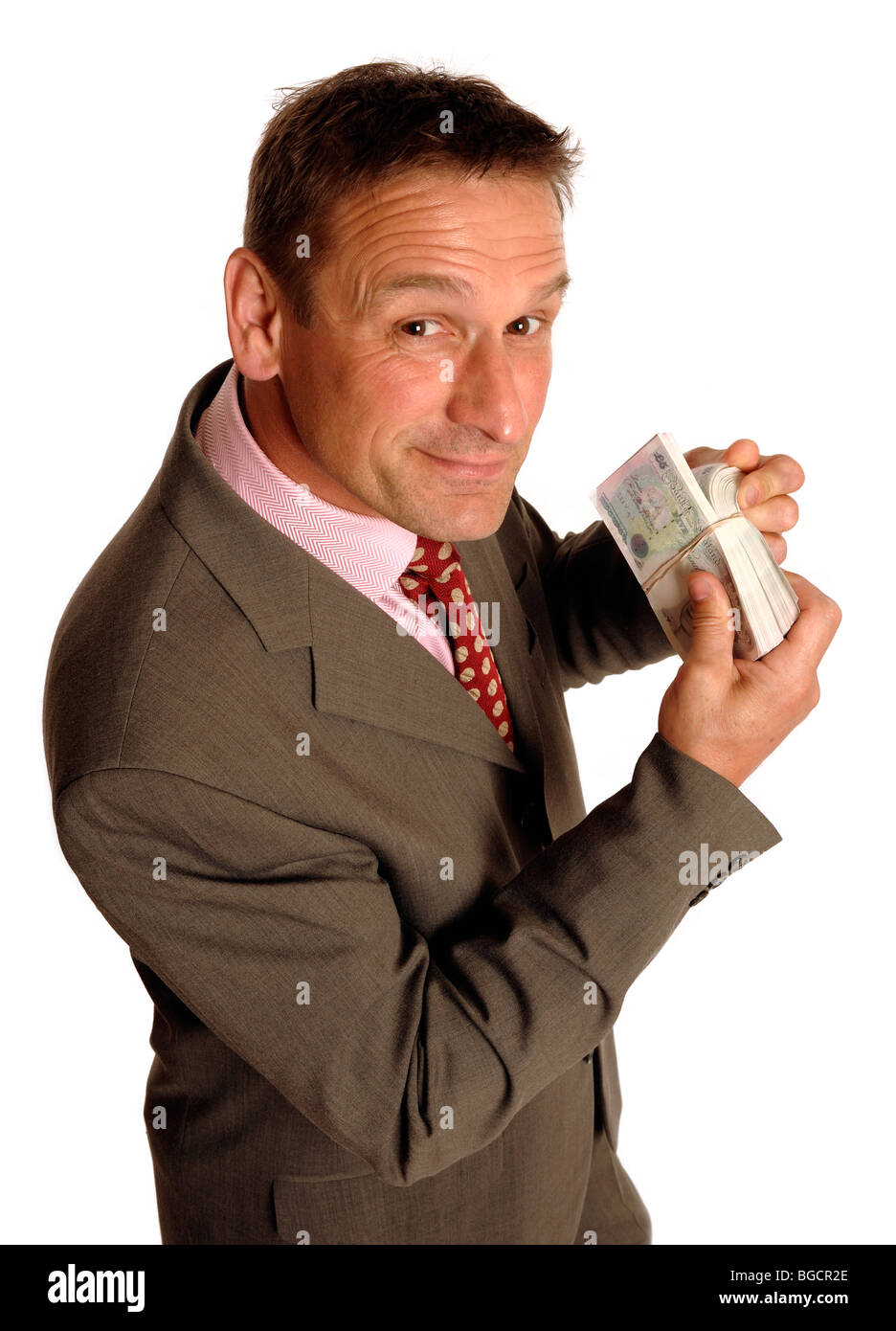 Geschäftsmann mit einem Bündel Geld Stockfoto