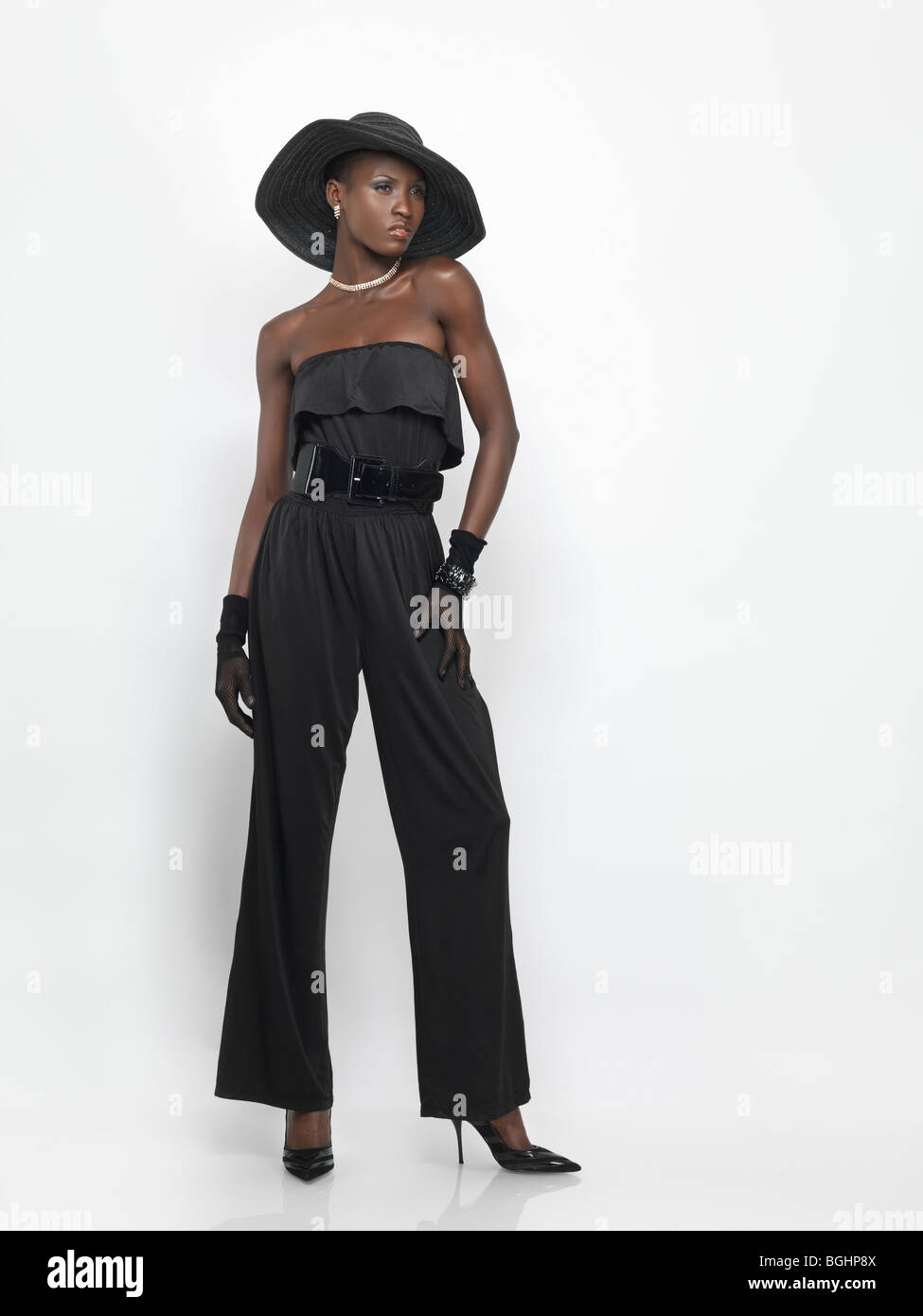 Lizenz erhältlich unter MaximImages.com elegantes junges Modemodell, das schwarz isoliert auf weißem Hintergrund trägt Stockfoto