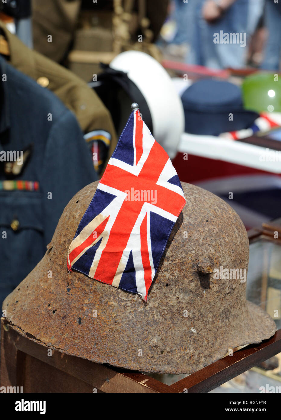 Korrodierter zweiten Weltkrieg deutsche Infanterie Helm hat einen Anschluß-Markierungsfahne am Fanartikel-Stand während Karneval hinein platziert. Stockfoto