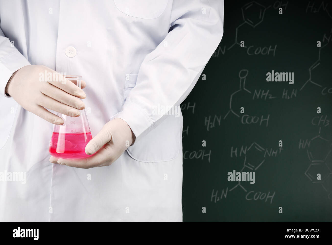 Wissenschaftler halten Fläschchen mit Flüssigkeit in Front ein Brett Stockfoto