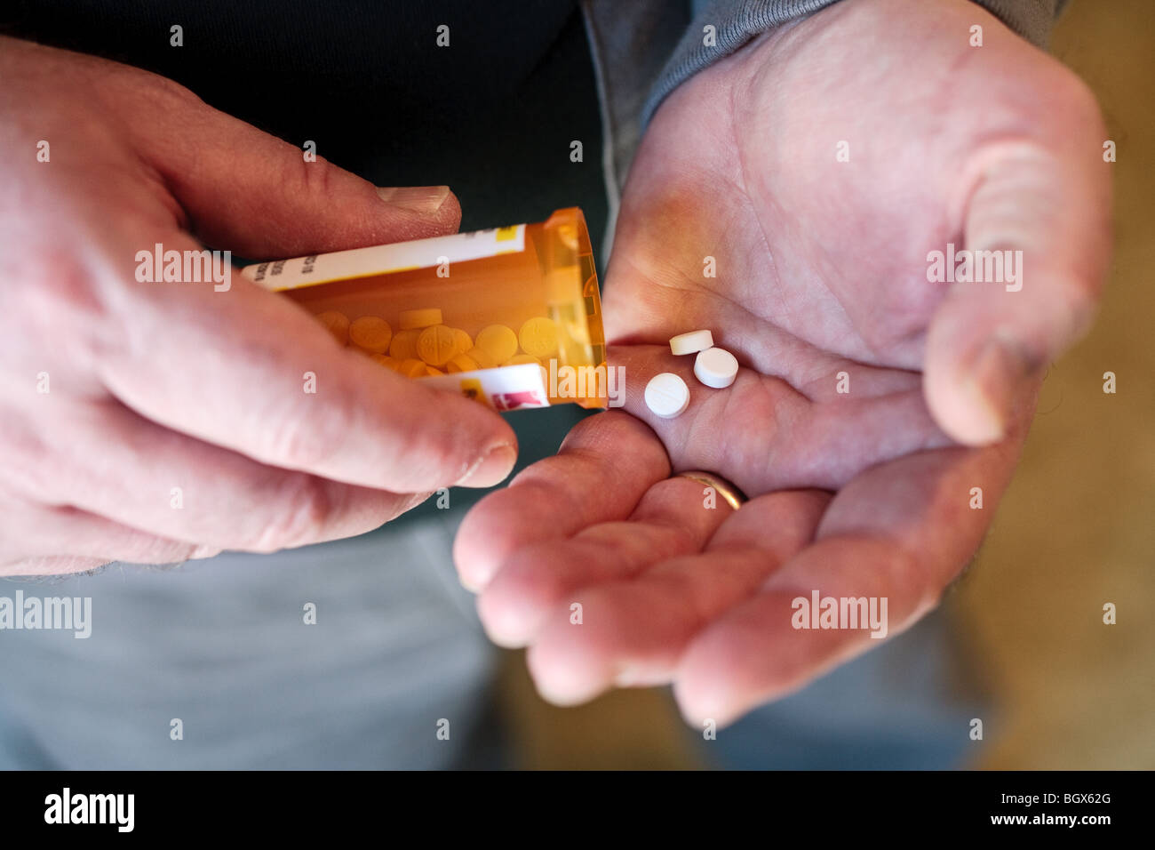 Eine Person, die verschreibungspflichtige Medikamente aus einer Flasche zu entfernen. Stockfoto
