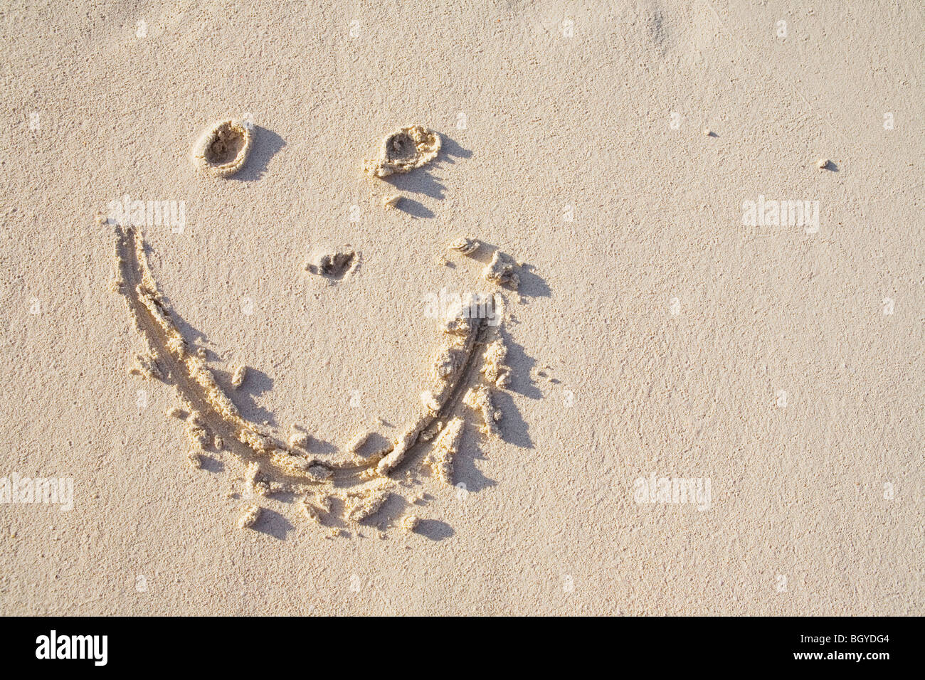 Glückliches Gesicht im sand Stockfoto