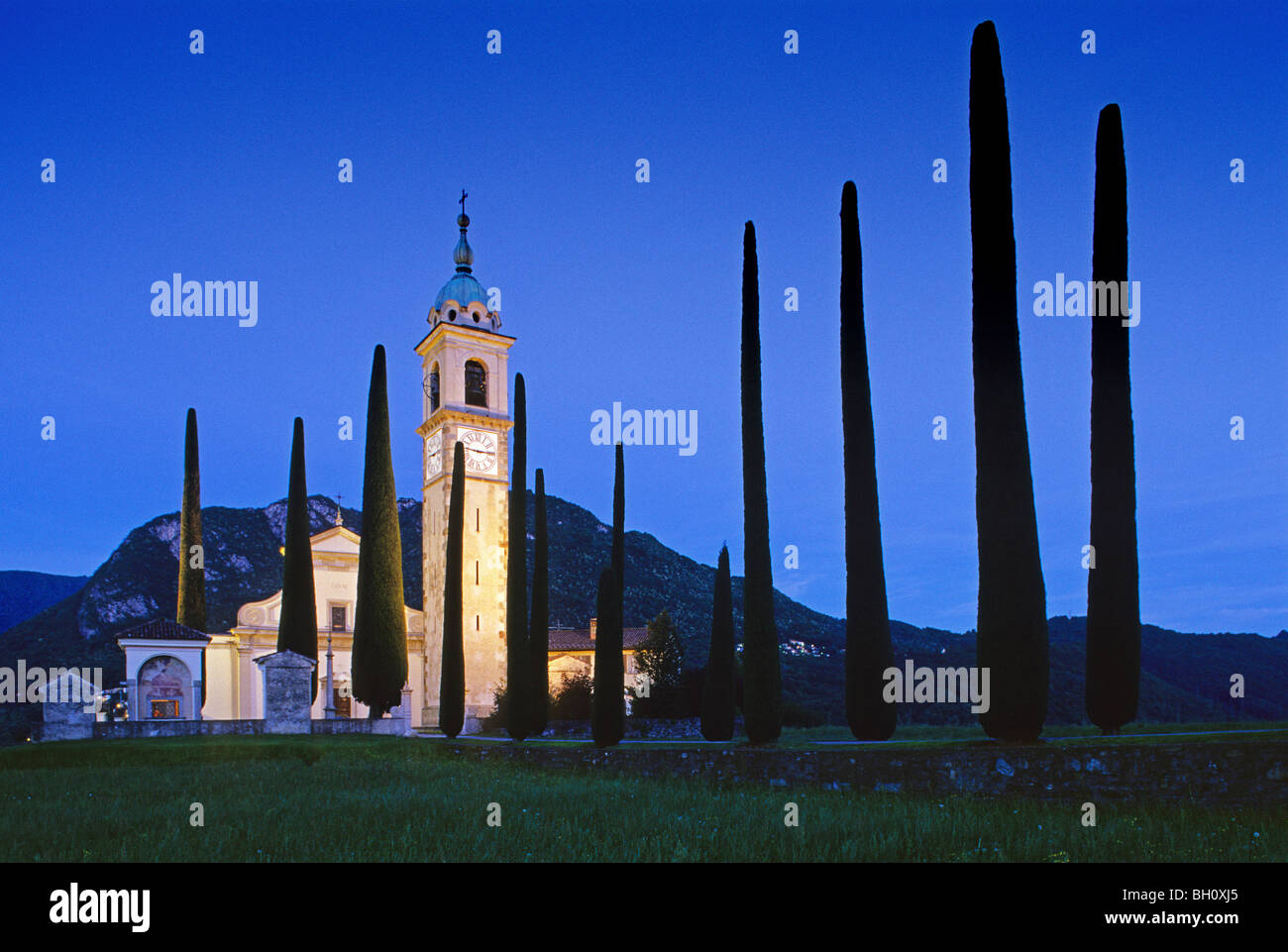 Gasse mit Zypressen, die beleuchteten Kirche Sant´Abbondio in den Abend, Tessin, Schweiz, Europa Stockfoto