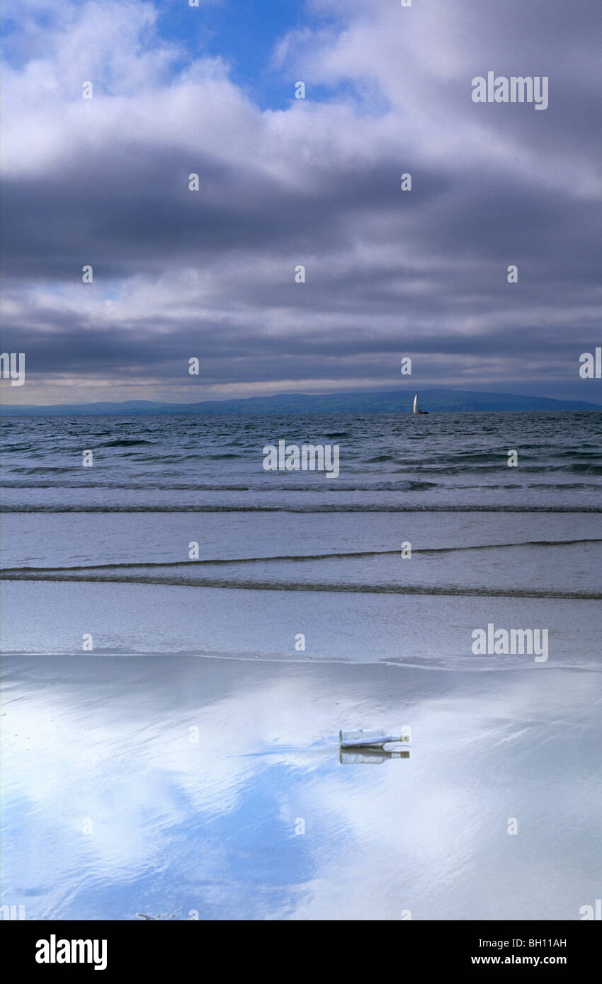 Eine Flaschenpost am Strand unter bewölktem Himmel, Portrush, County Antrim, Irland, Europa Stockfoto