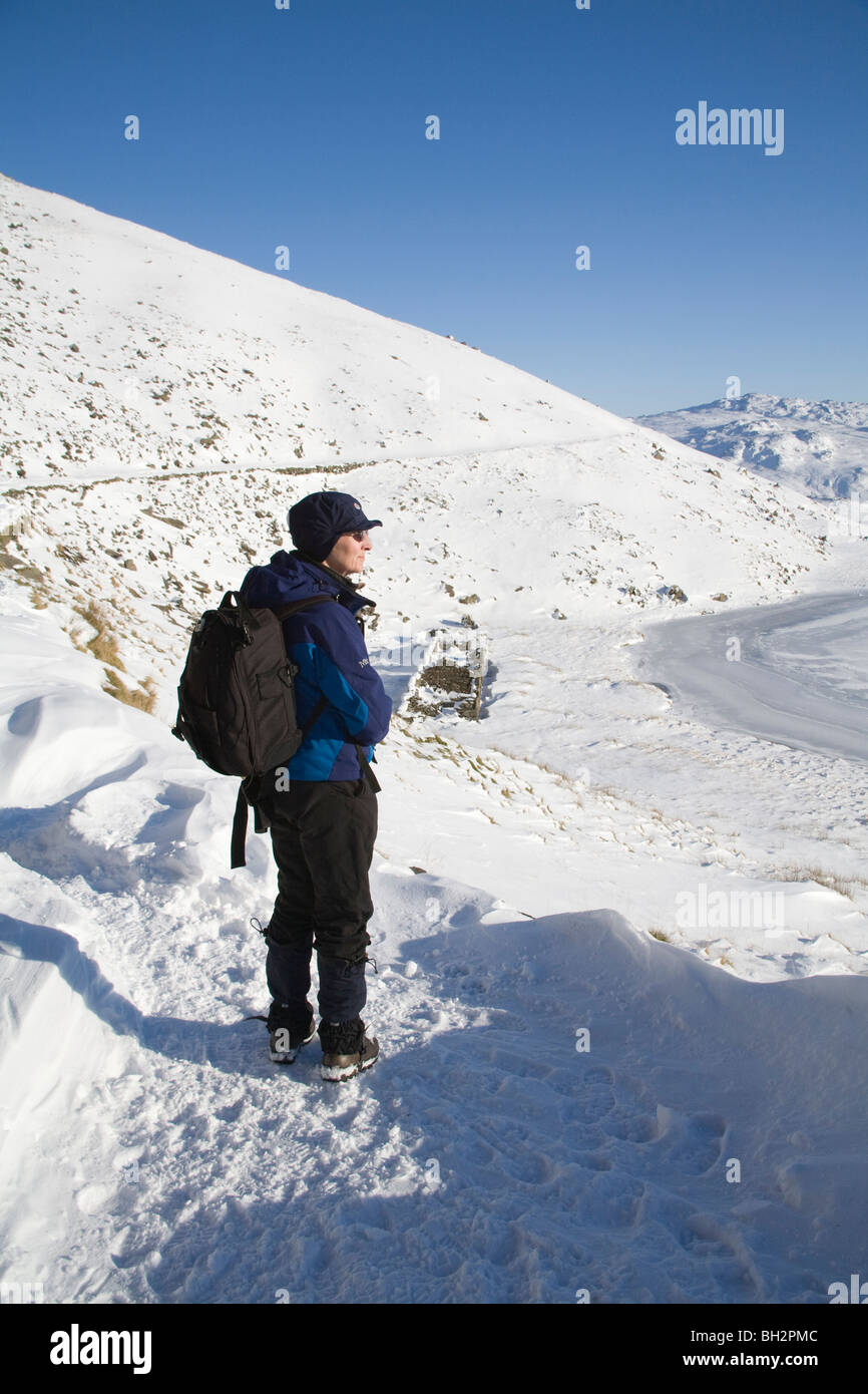 Gwynedd North Wales UK Januar Wanderer auf Bergleute Spur mit Blick auf den gefrorenen Llyn Teyrn mit dickem Schnee auf beliebten gut markierten Öffentlichen Fußweg Stockfoto