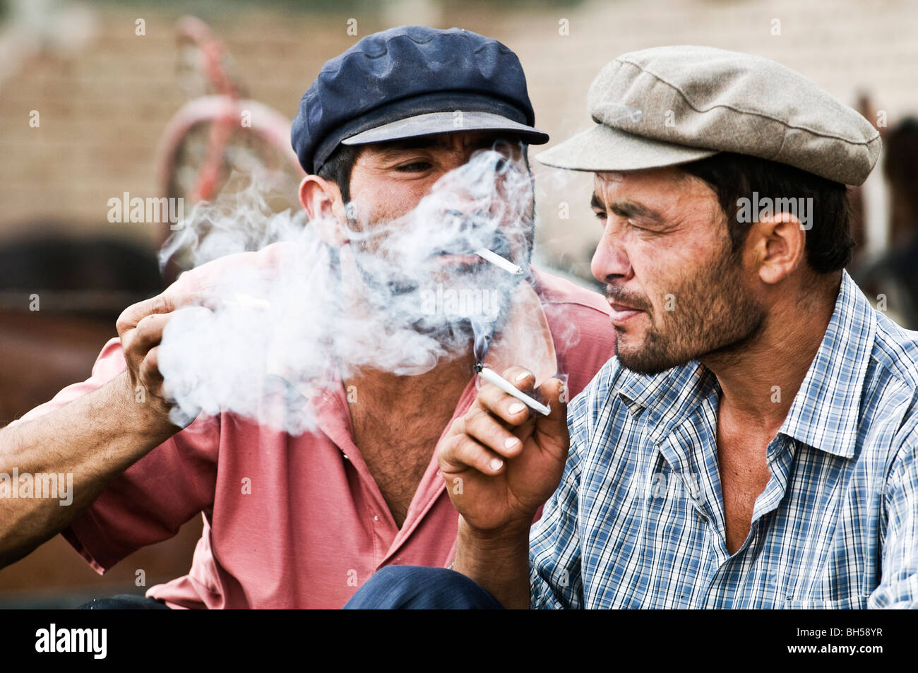 Das Rauchen auf dem Sonntagsmarkt in Kashgar, China zusammen. Stockfoto