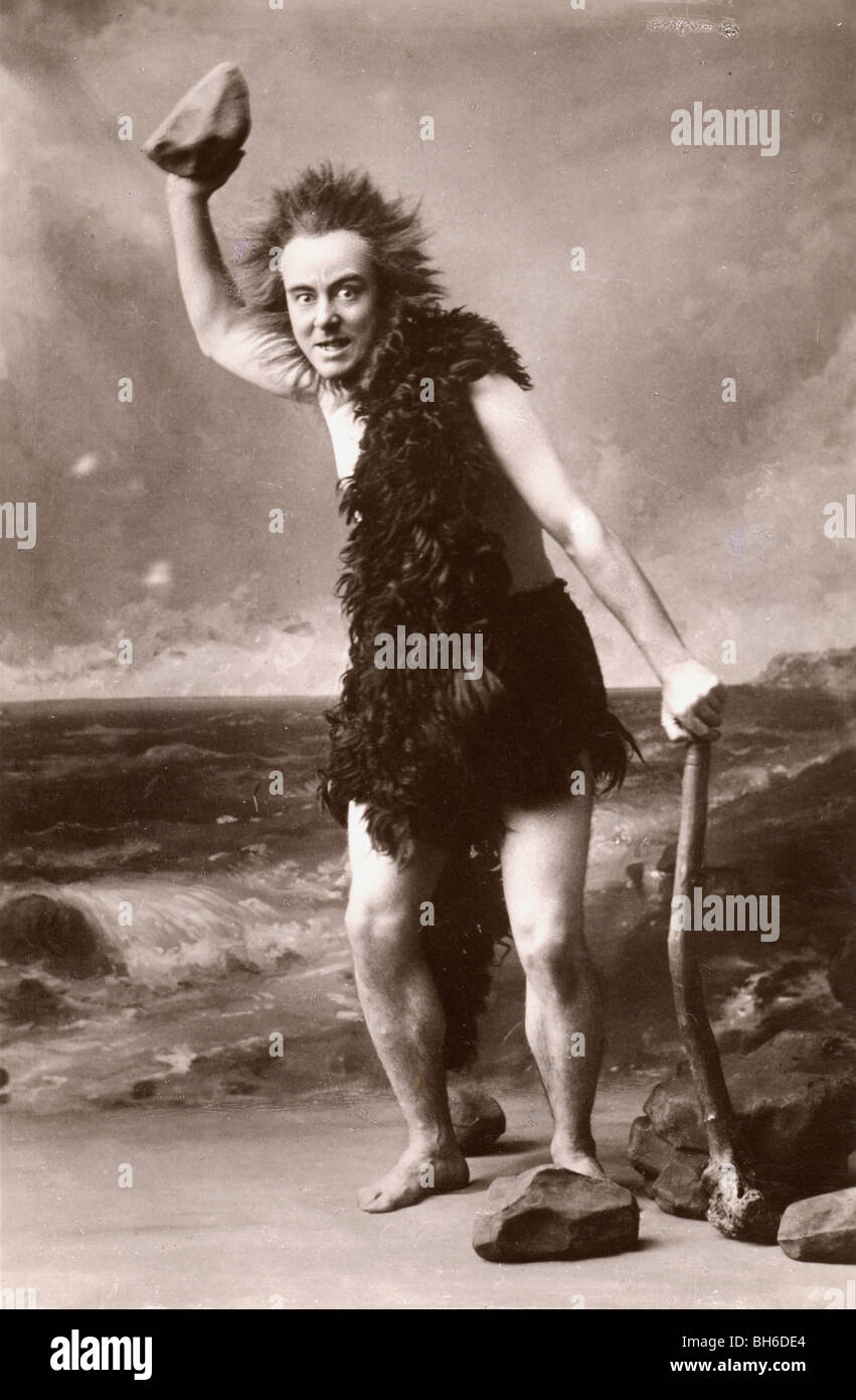 Caveman mit Shillelagh schwang ein Rock Stockfoto