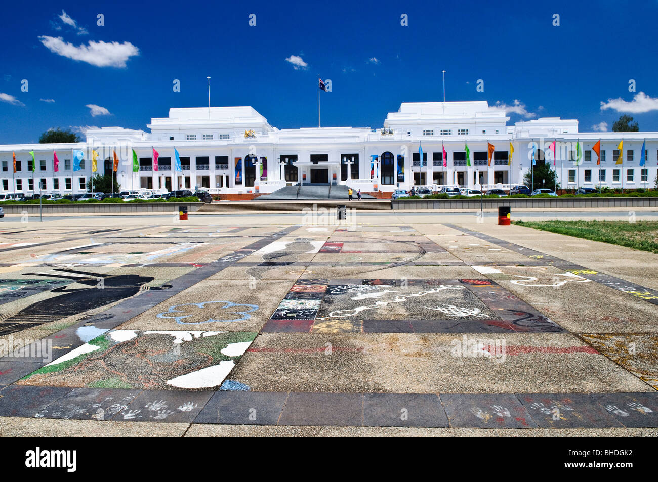 Aboriginal Tent Embassy Old Parliament House Canberra Australien | CANBERRA, Australien – gemalte Bodenmalereien in den Farben der Aboriginal-Flagge markieren den platz gegenüber dem Old Parliament House, dem Ort der Aboriginal Tent Embassy. Vier Aktivisten der First Nations gründeten das Protestlager am 26. Januar 1972, um Landrechte zu fordern, und es gilt weiterhin als einer der am längsten andauernden politischen Proteste in der australischen Geschichte. Stockfoto