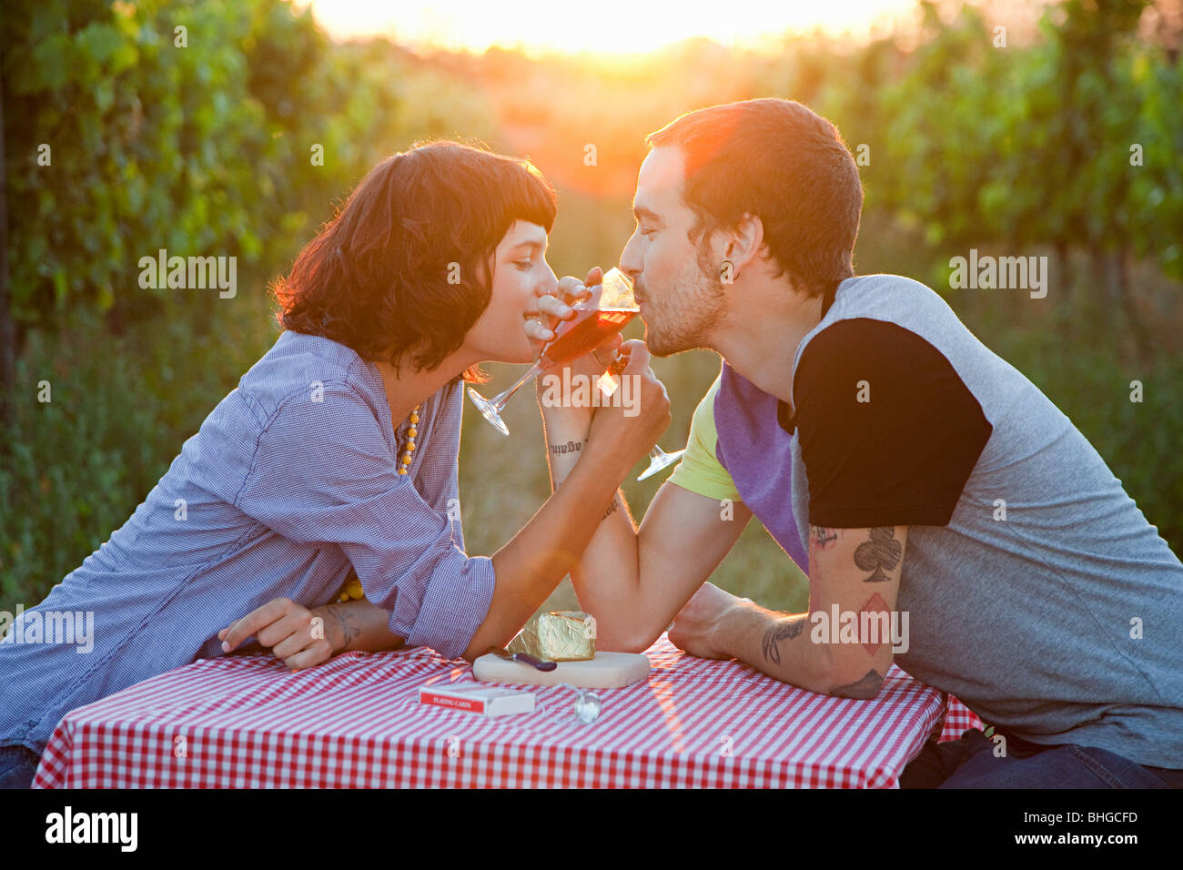 Paar, trinken Wein in einem Feld Stockfoto