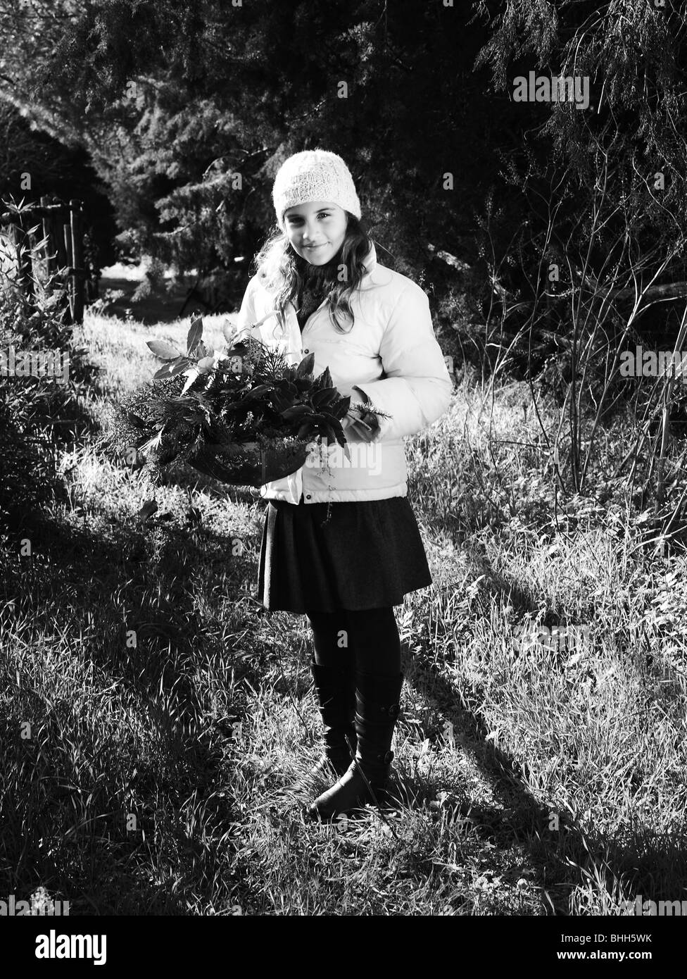 Ein Mädchen, Kommissionierung Kräuter in einem Korb, Italien. Stockfoto