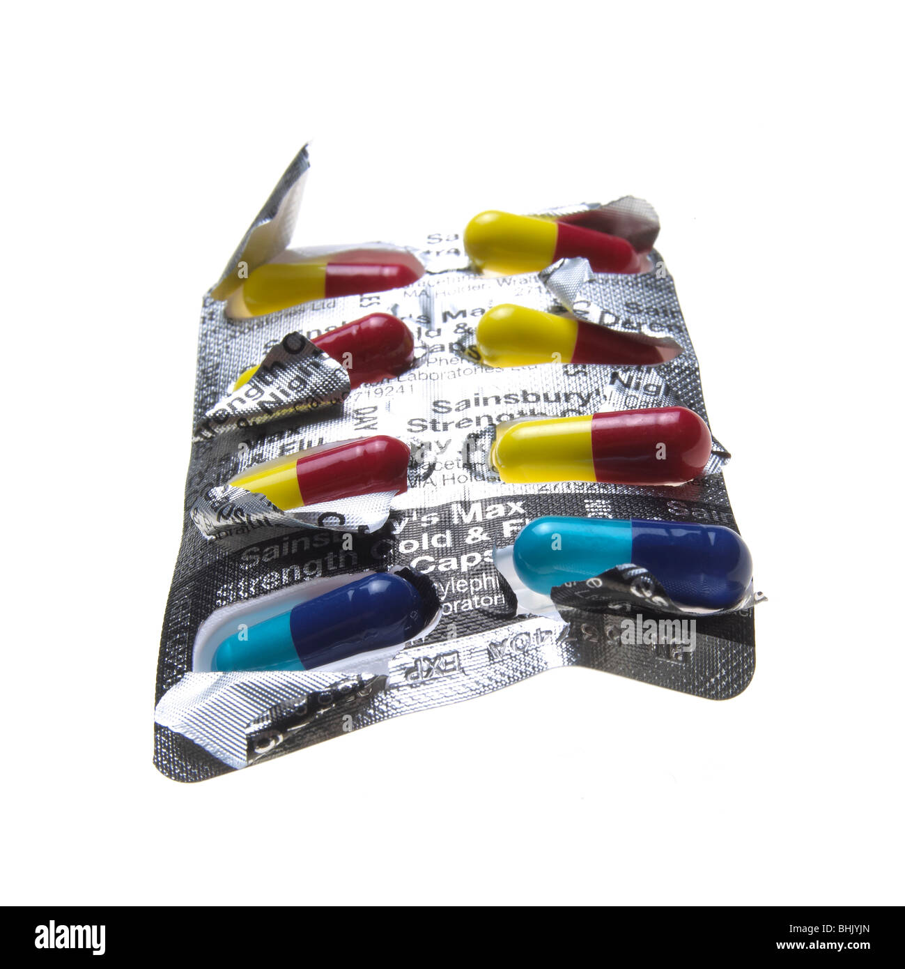 blaue, rote und gelbe Grippe Kapseln auf weißem Hintergrund Stockfoto