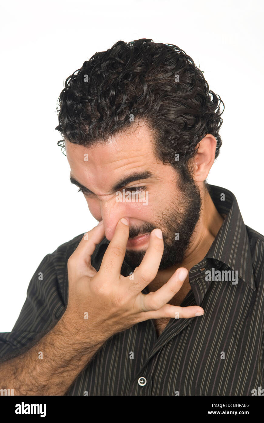 25 Jahre alt orientalische Mann Hand über die Nase vom schlechten Geruch Stockfoto