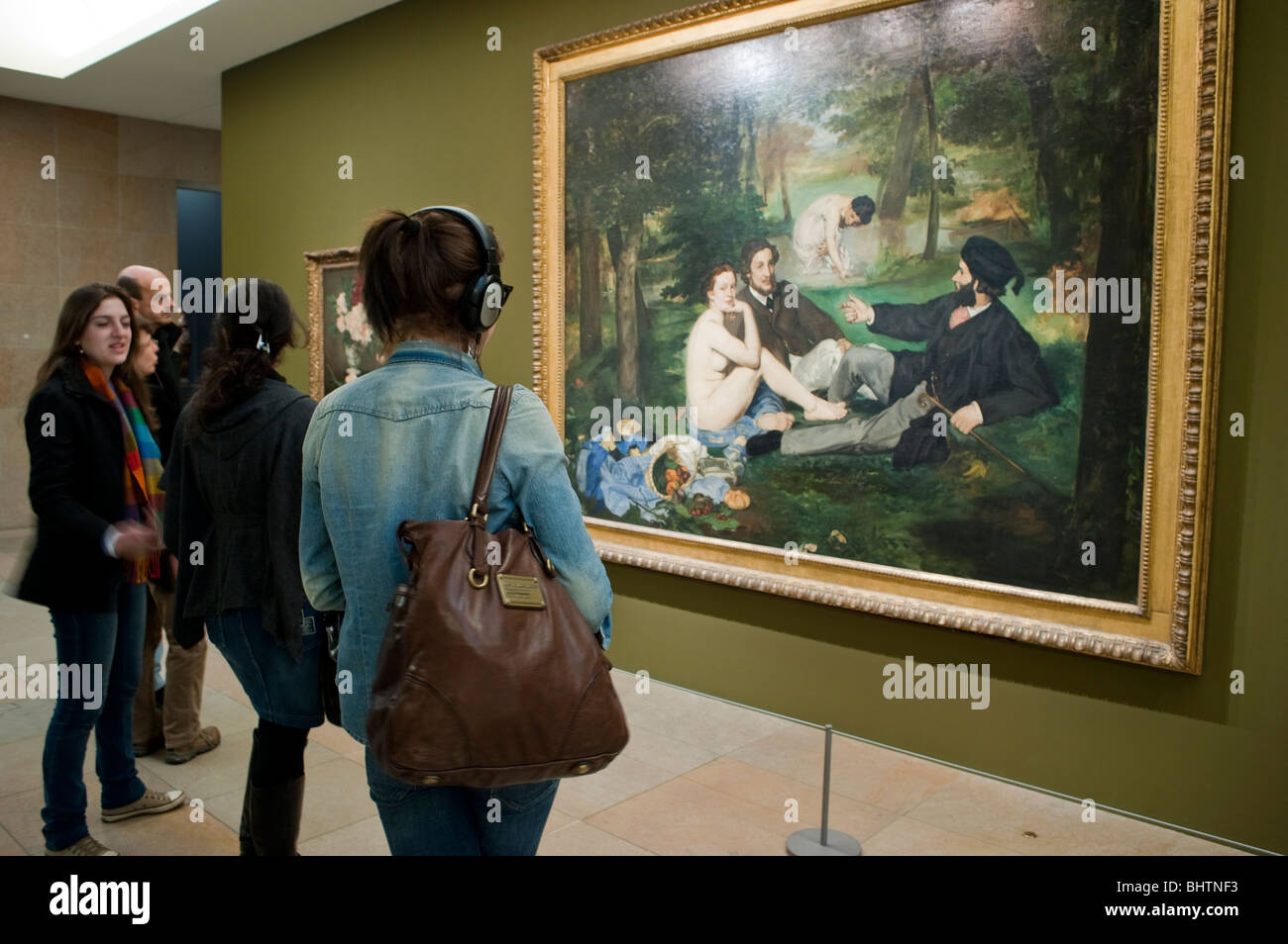 Paris, Frankreich - die Menschen betrachten das impressionistische Gemälde „Dejeuner sur l'herbe“ im Inneren des Orsay-Museums, Courbet, das die bildende Kunst und historische Feiertage bewundert Stockfoto