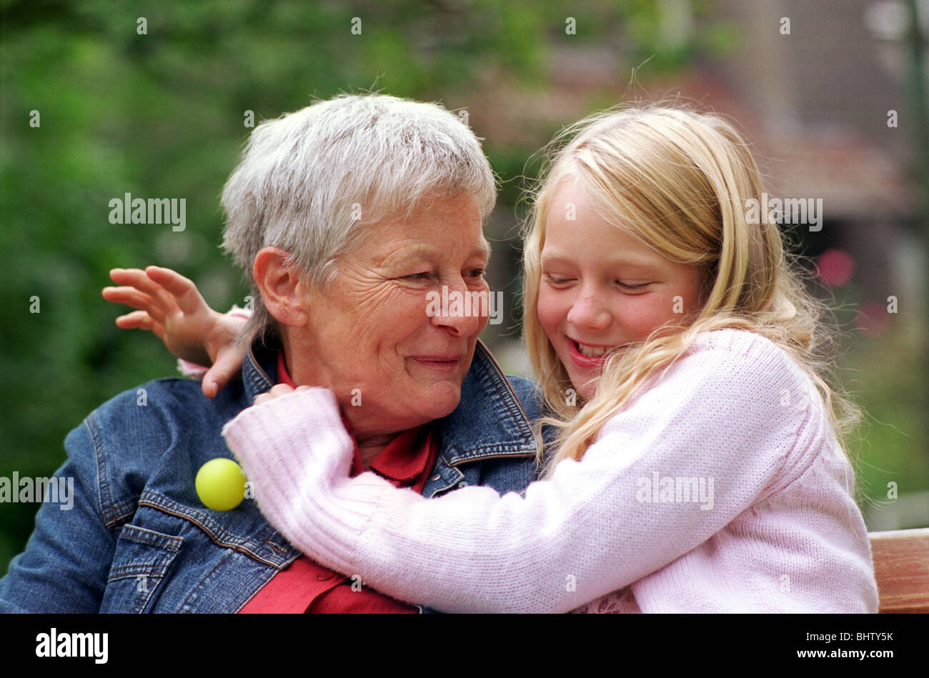 Enkelin Oma umarmt Stockfoto