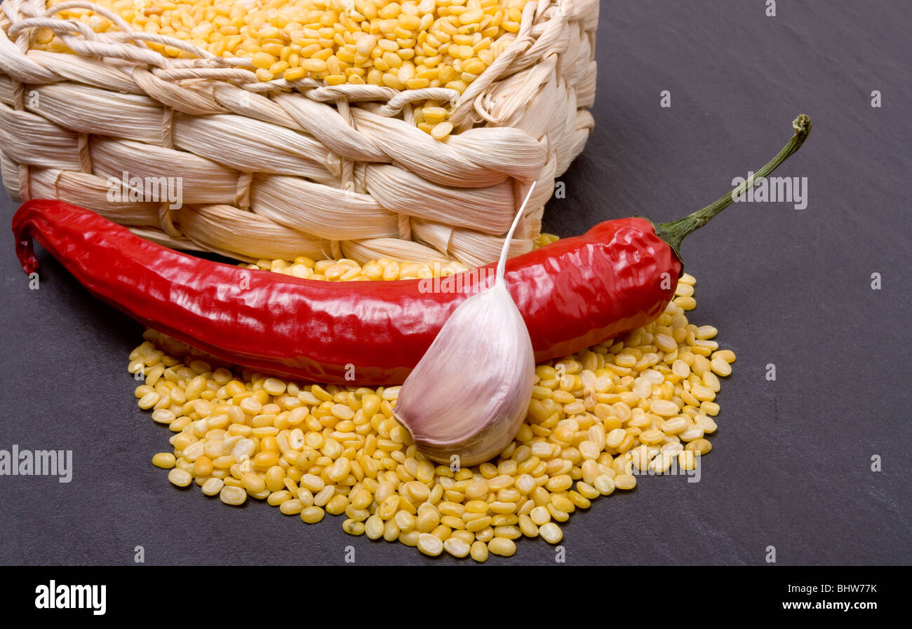 Würzige Linsensuppe curry Zutaten aus gelben Linsen, rote Chili und Knoblauch auf dunklem Schiefer. Stockfoto