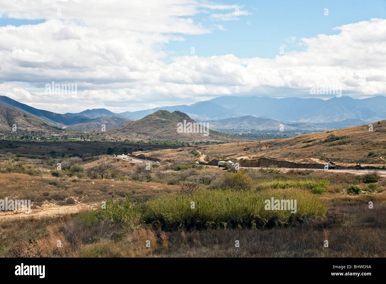 Autobahn schlängelt sich durch Tal von Oaxaca beringt mit herrlichen Bergpanoramen & Wolke Formationen ländlichen Staat Oaxaca Mexico Stockfoto