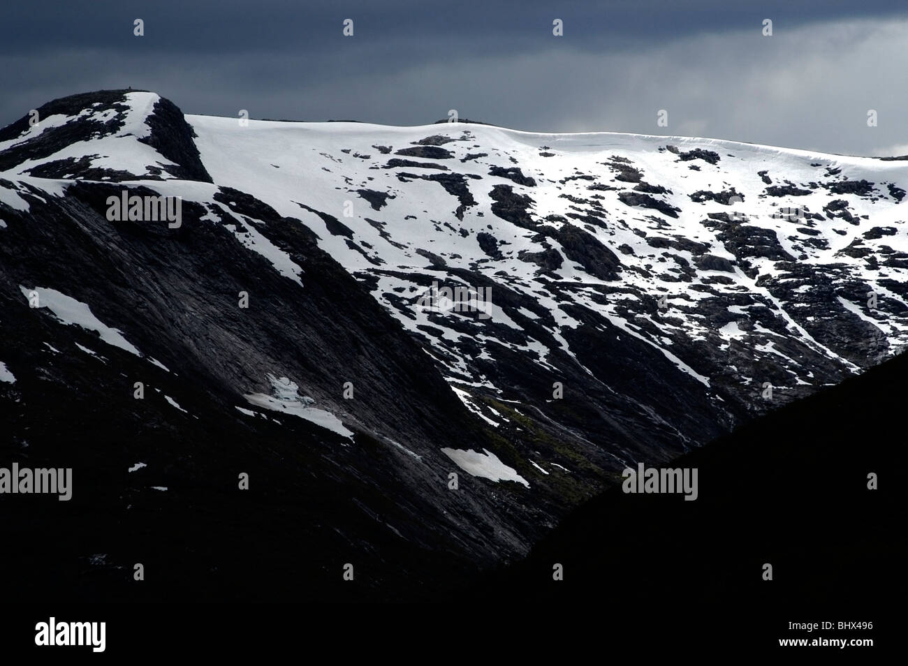Berg in Norwegen Sonnenstrahlen fangen eine Schnee bedeckt Stockfoto