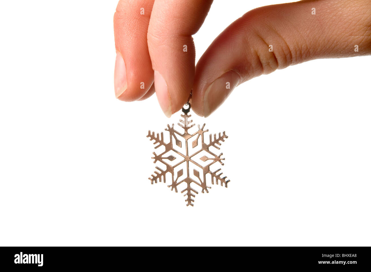 Hand halten silberne Schneeflocke Stockfoto