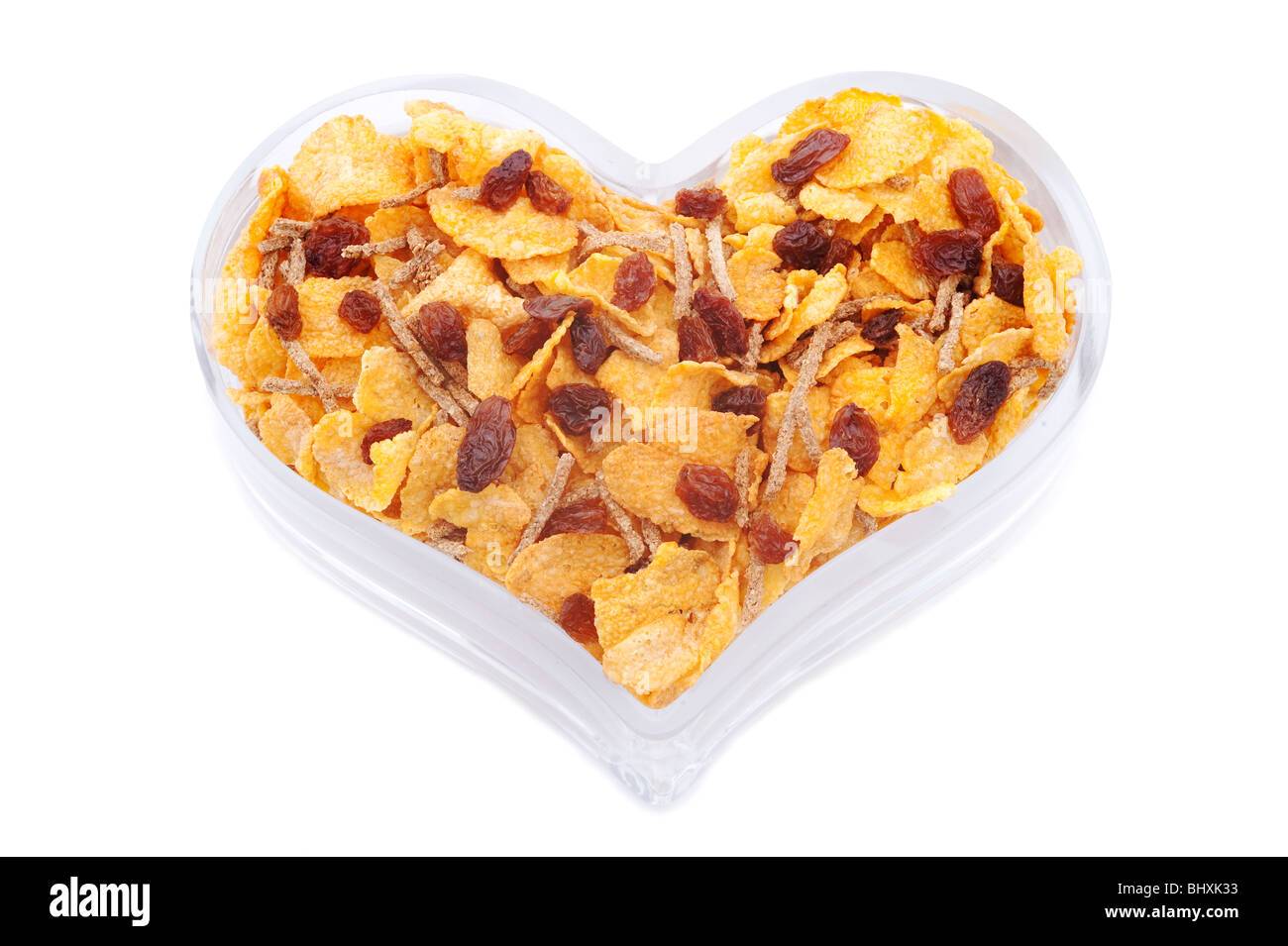 Herzförmige Schüssel mit gesunden Cerealien Stockfoto