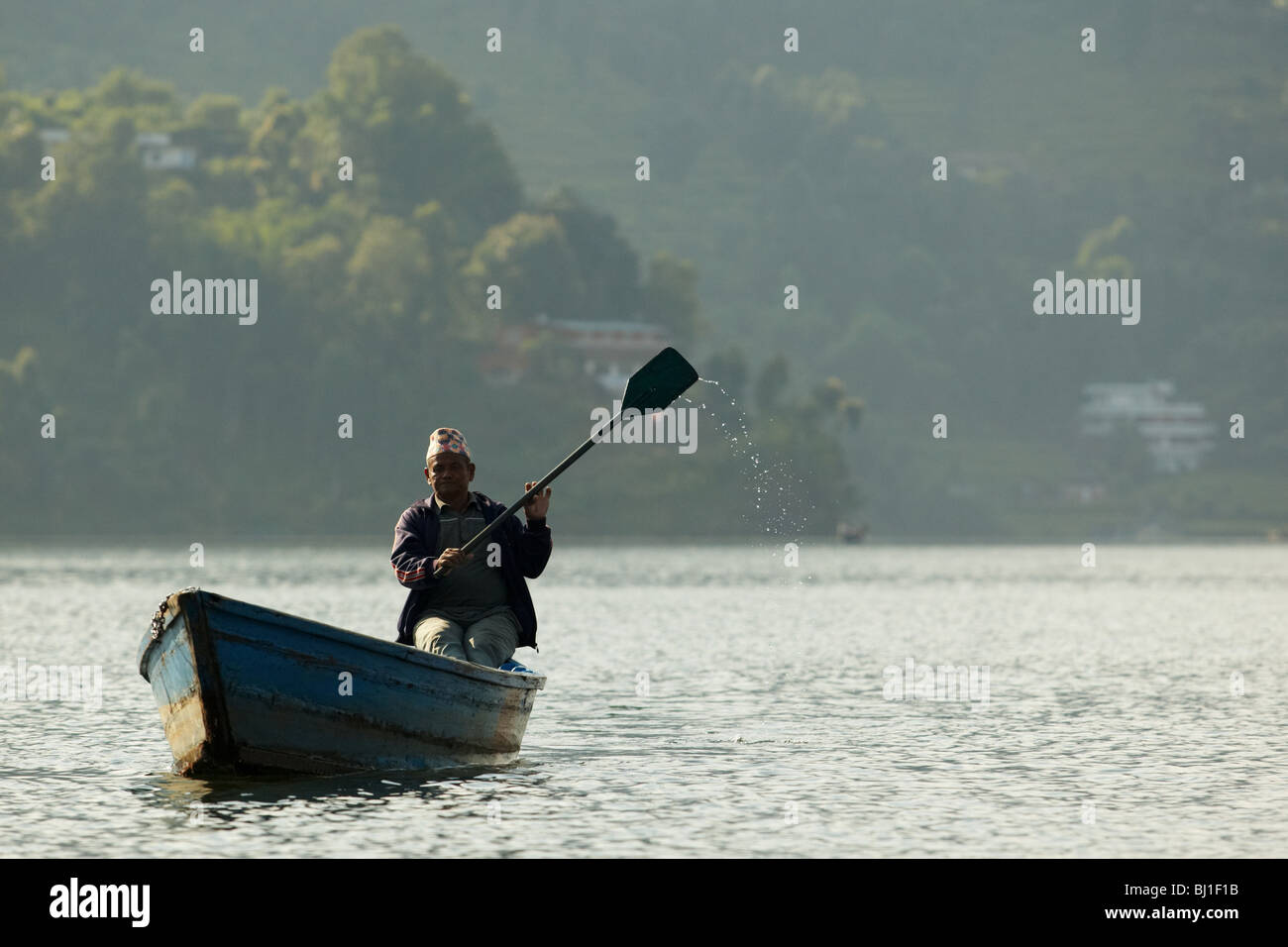 Ein Mann in einem Kanu auf Pewha-See in Pokhara, Nepal auf Montag, 26. Oktober 2009 Rudern. Stockfoto