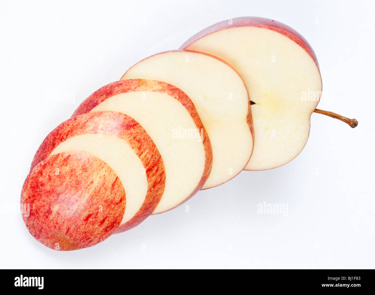 Eine in Scheiben geschnittene rote Apfel isoliert auf weißem Hintergrund. Stockfoto