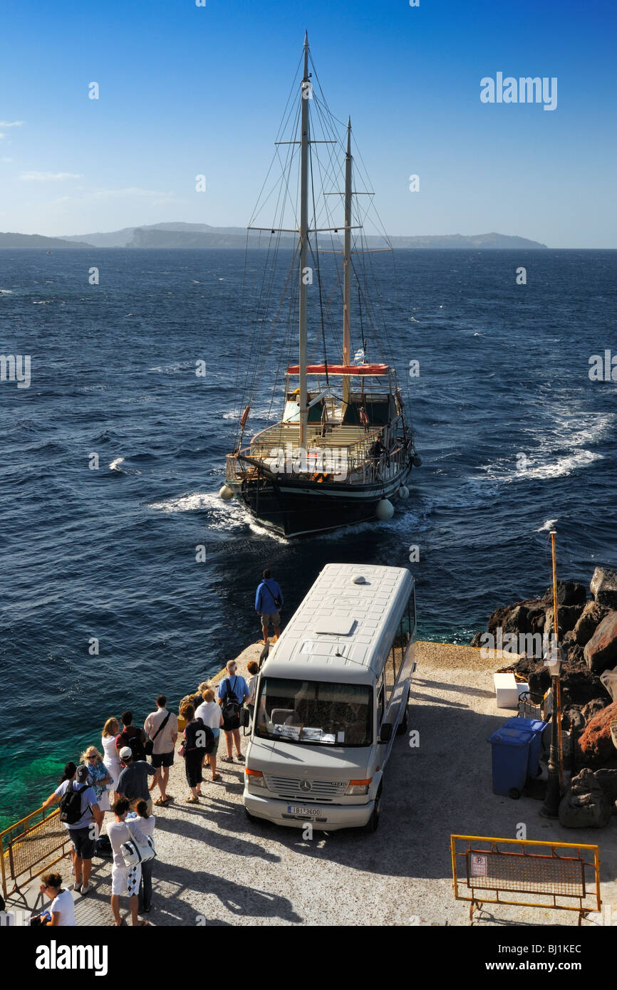 Ein Segel Boot Pick-up Touristen am Hafen von Oia, Santorin, Griechenland Stockfoto