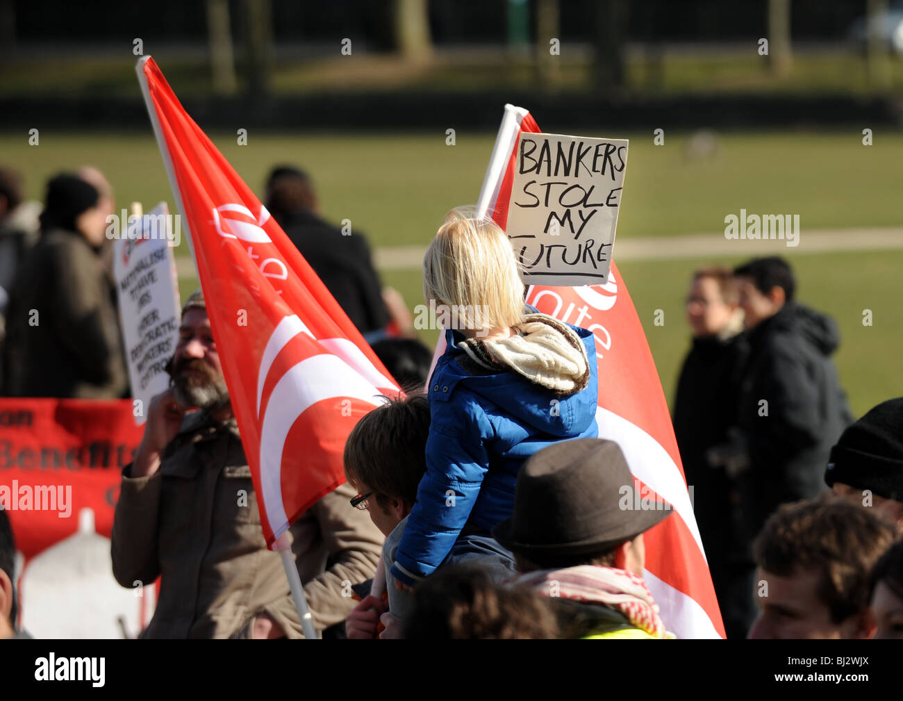 Kleines Kind mit einem Plakat protestieren über Banker bei einer Demonstration gegen Arbeitsplatzverluste in Brighton UK Stockfoto