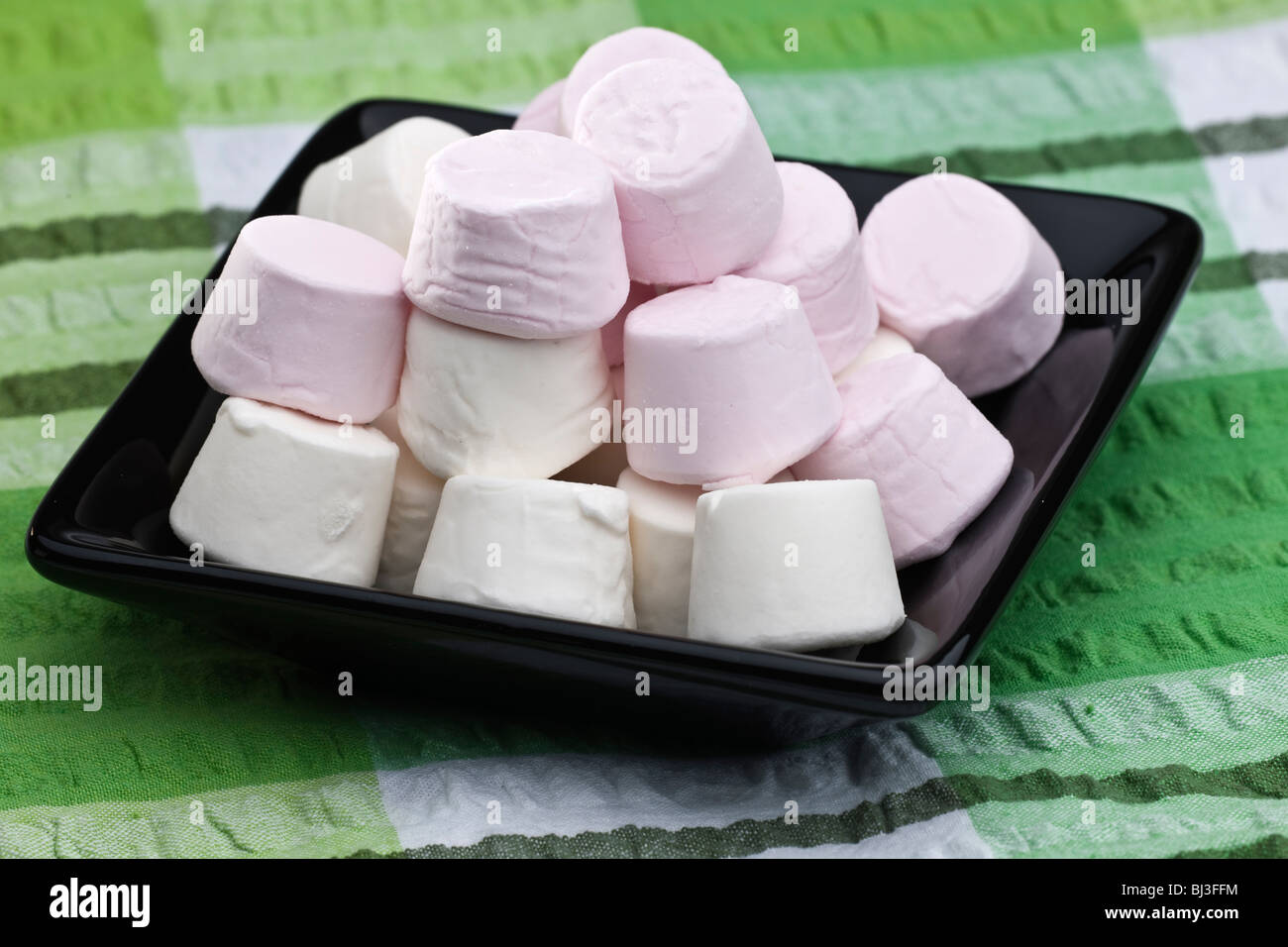 Schwarze Quadrat Keramikplatte gefüllt mit rosa und weiße marshmallows Stockfoto