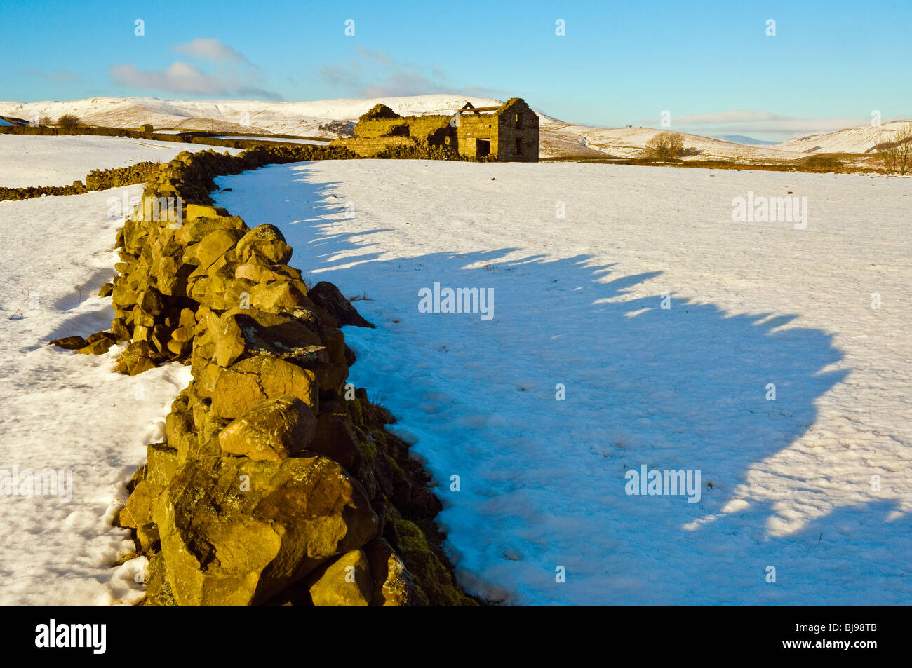 Wand und Scheune in der Nähe von Hawes In Wensleydale, North Yorkshire im Schnee Stockfoto