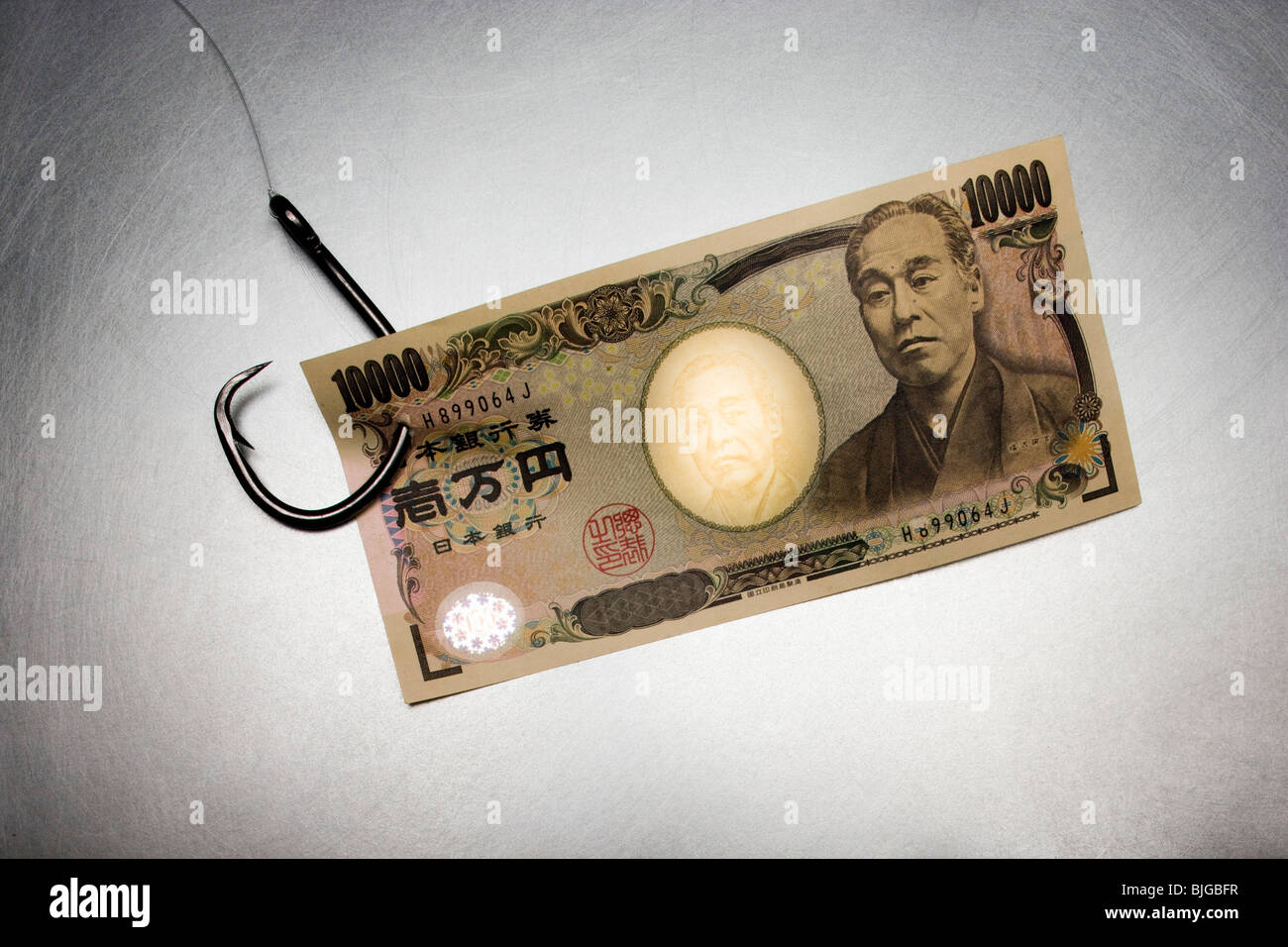 Geld auf ein Angelhaken Stockfoto