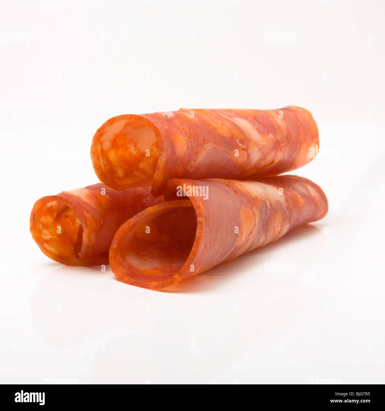 Gerollte Chorizo-Scheiben auf weißen Hintergrund isoliert. Stockfoto