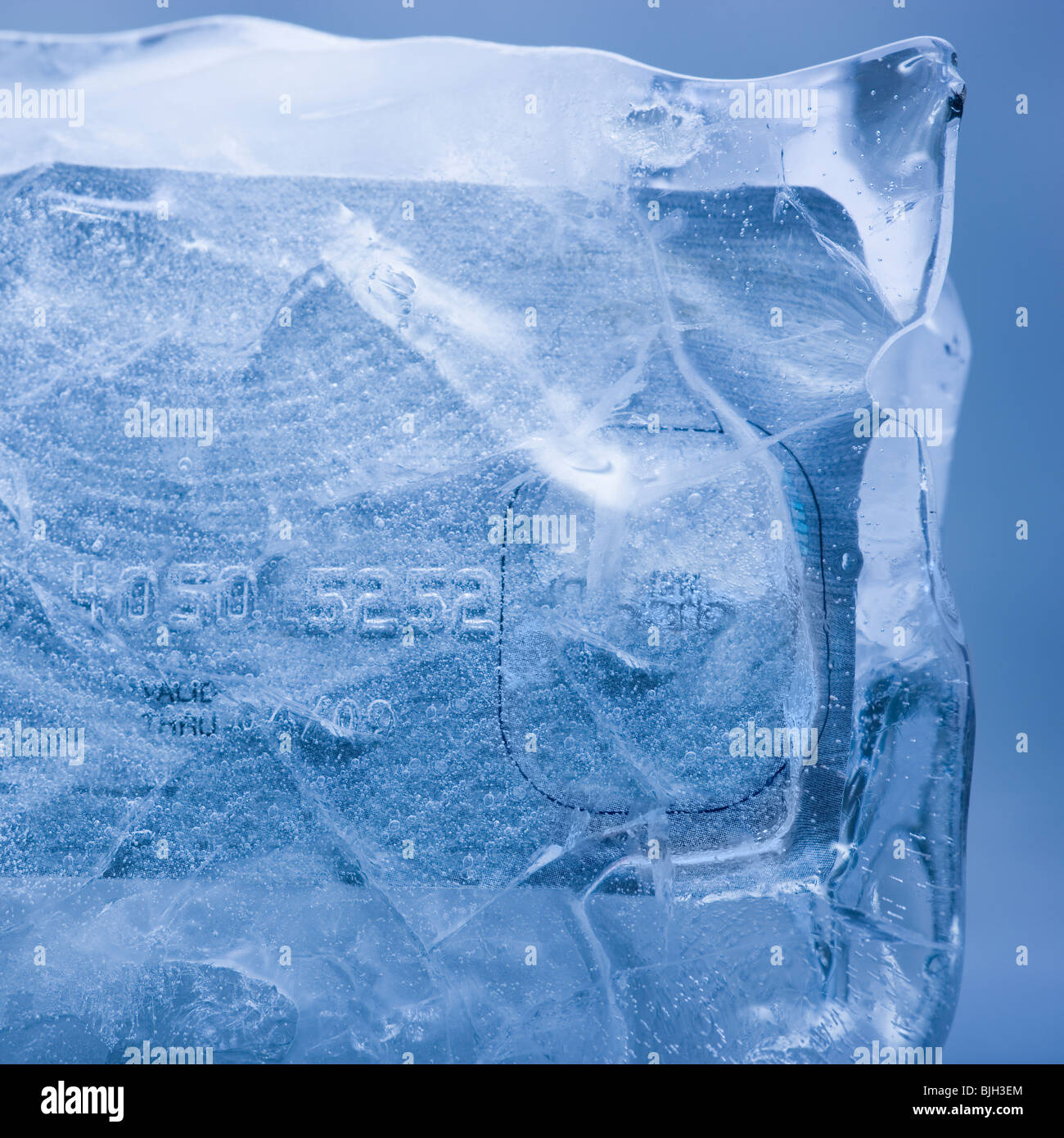 Kreditkarte in einem massiven Block aus Eis eingefroren Stockfoto