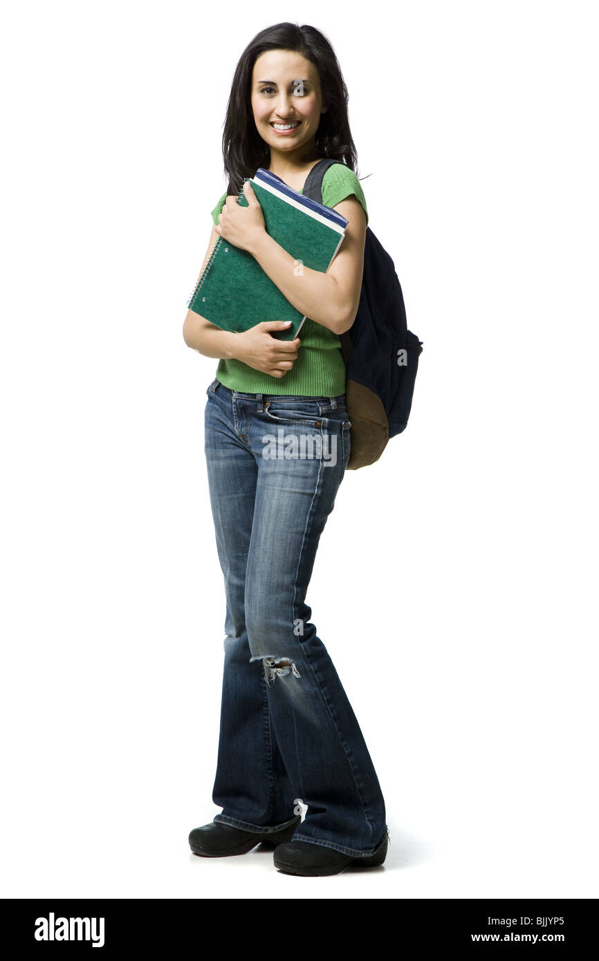 Frau mit Rucksack und Bücher lächelnd Stockfoto
