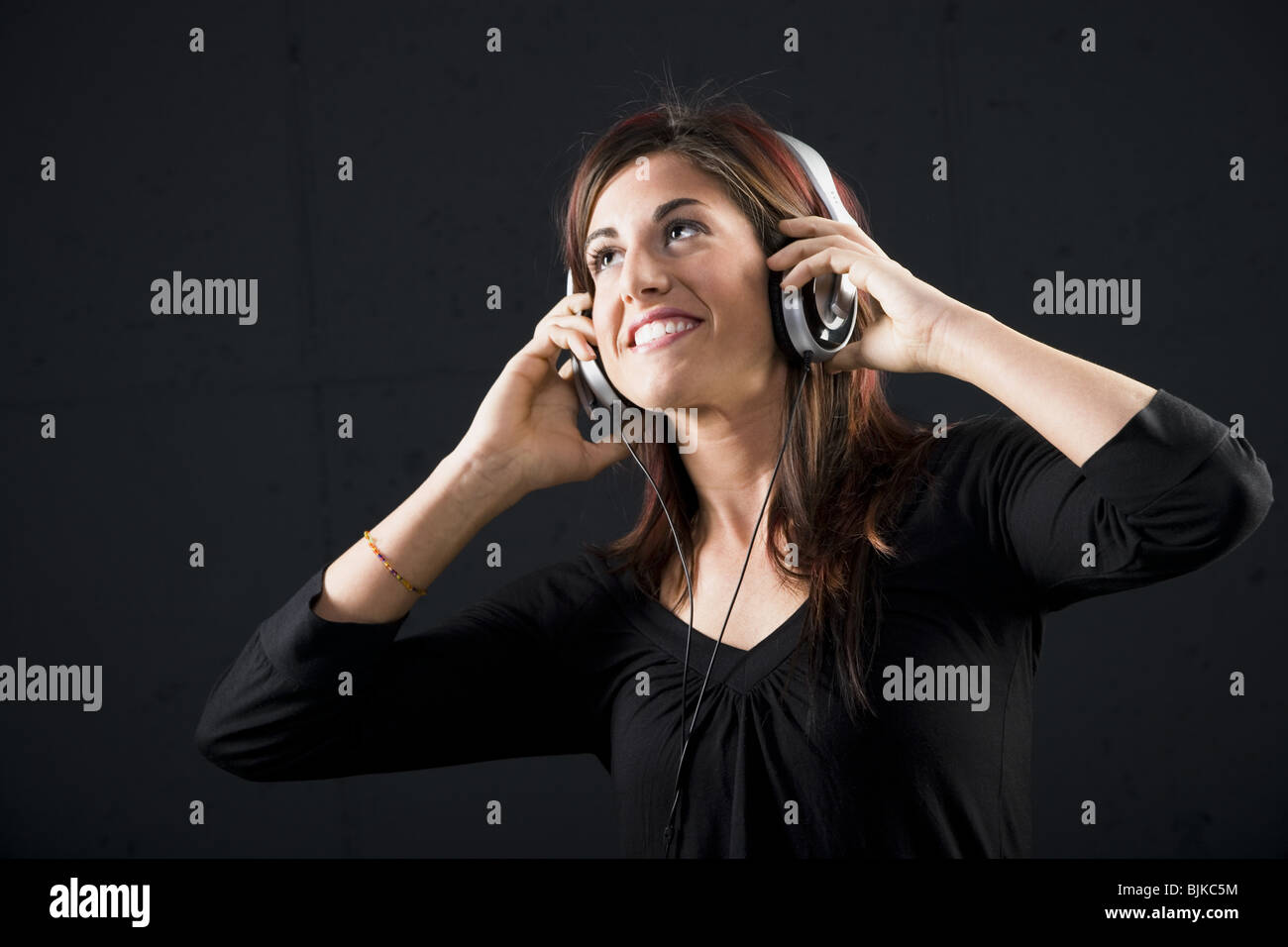 Frau mit Kopfhörern lächelnd Stockfoto