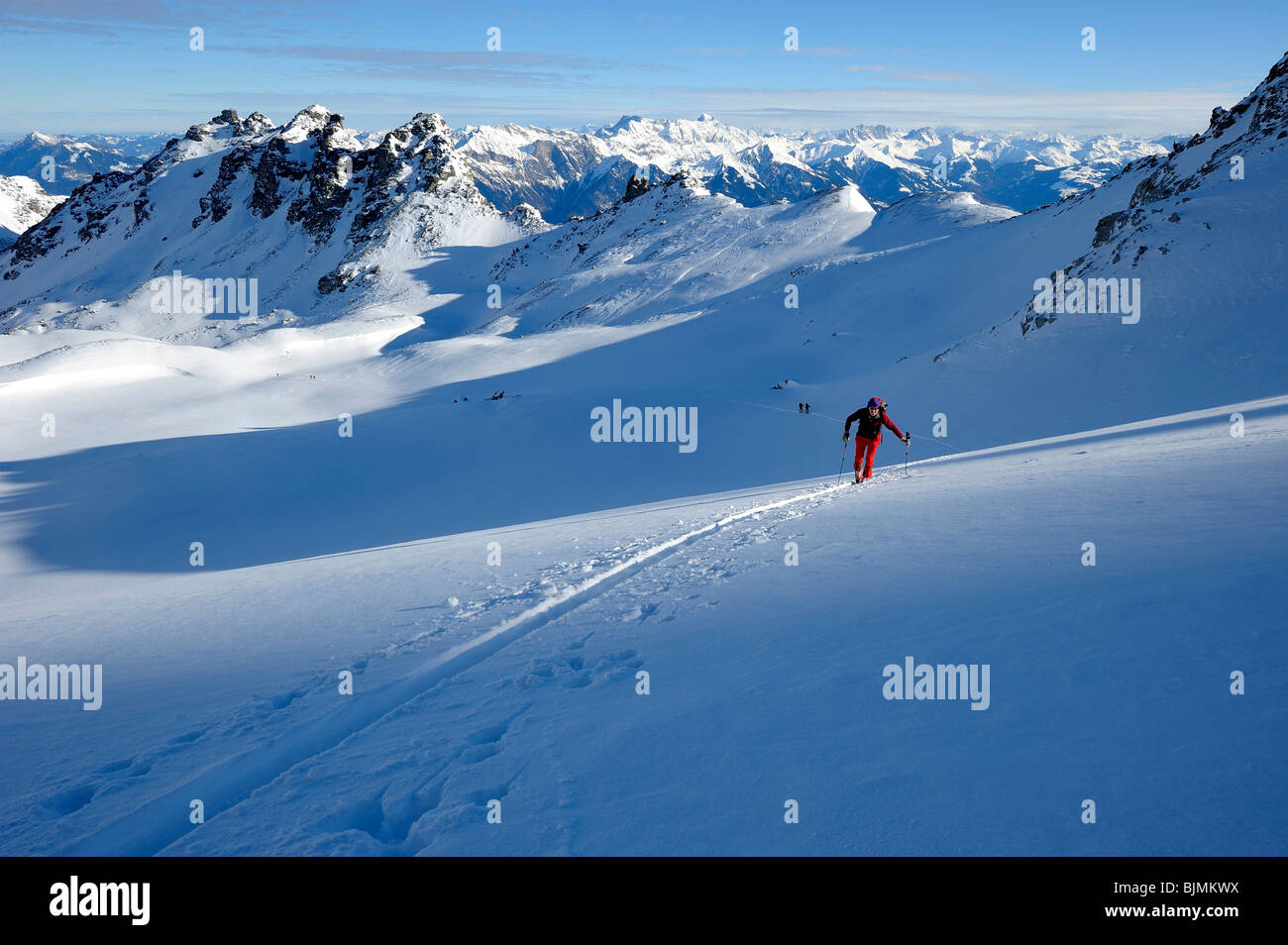 Backcountry Skifahrer mit Ski verfolgt vor dem Panorama der Berge Gipfel, Chur, Graubündens, der Schweiz, Europa Stockfoto